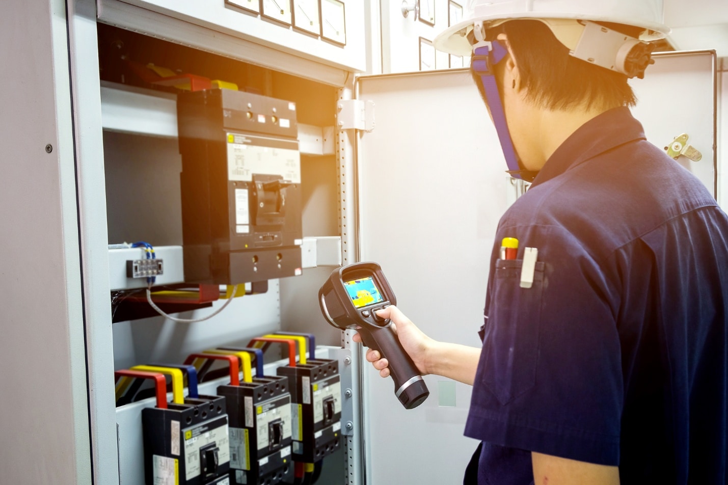 A person in a hard hat using a camera AI-generated content may be incorrect.