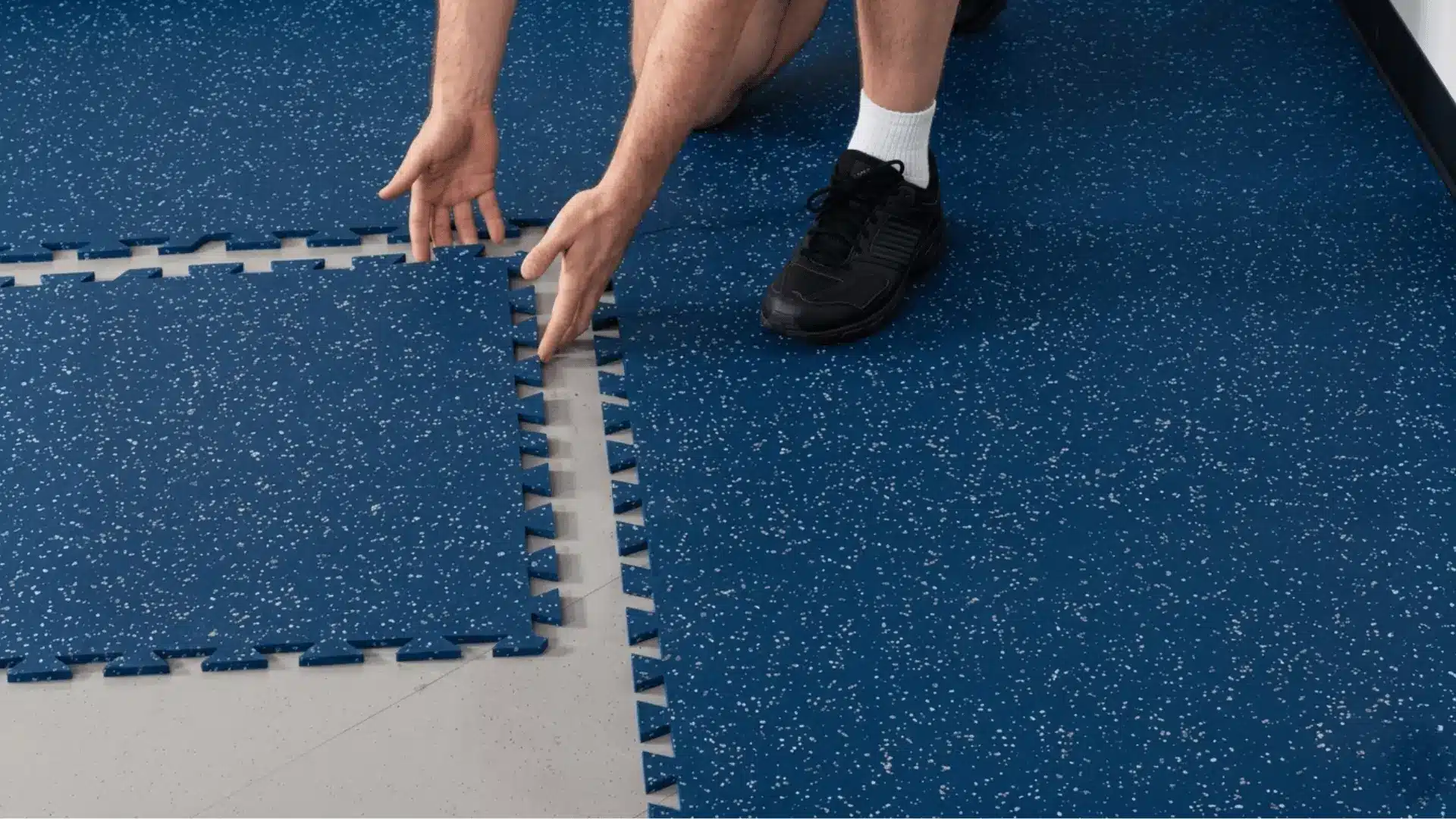 a high quality picture of man placing rubber flooring