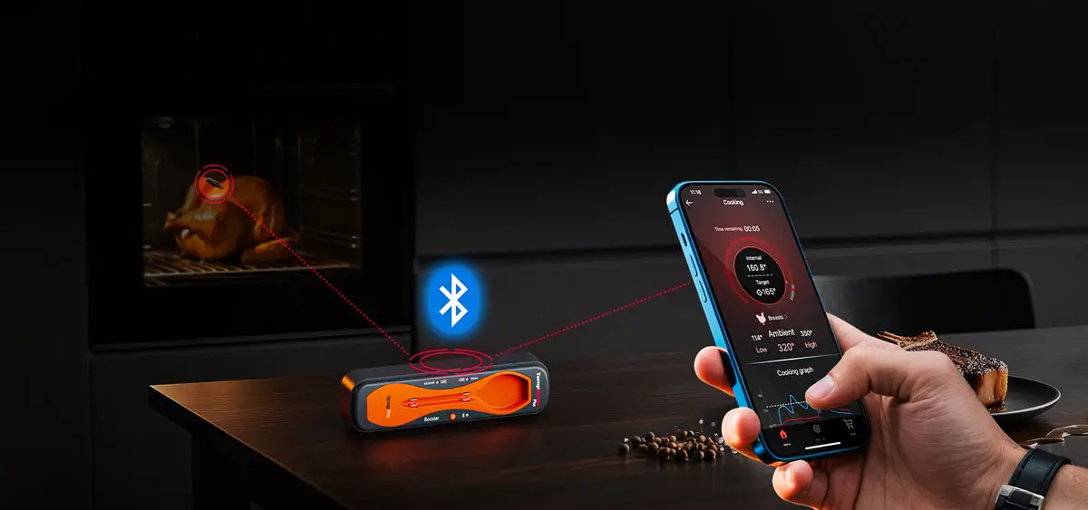 Bluetooth meat thermometer monitoring a roasting chicken in modern kitchen with smartphone control