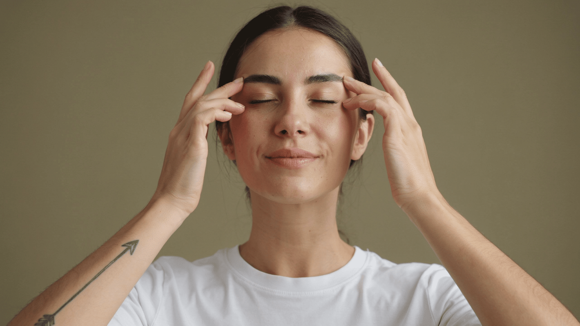 Woman practicing face yoga exercises for a natural face skin tightening routine at home