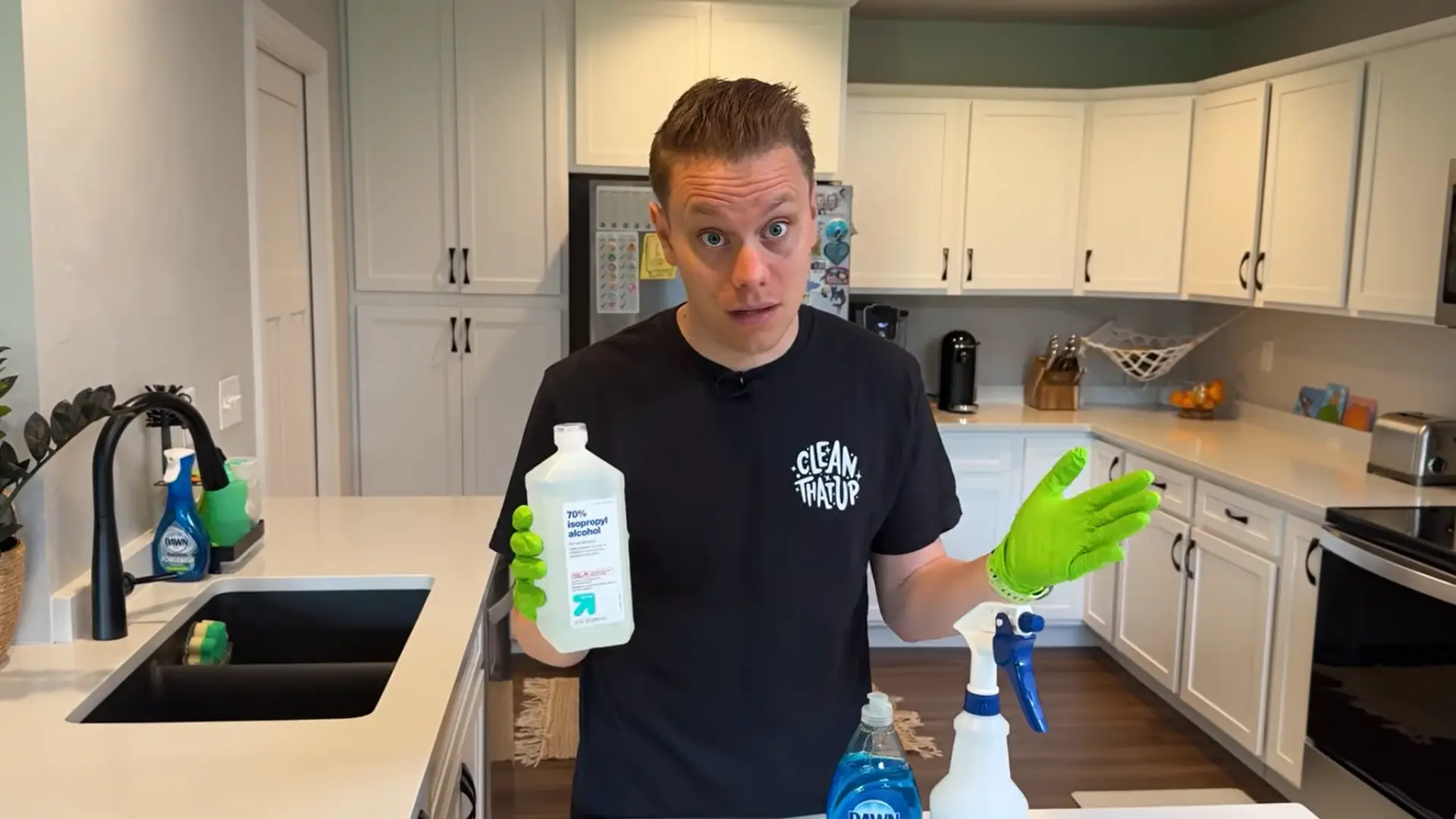 spraying isopropyl alcohol on quartz countertop for safe disinfecting in modern kitchen