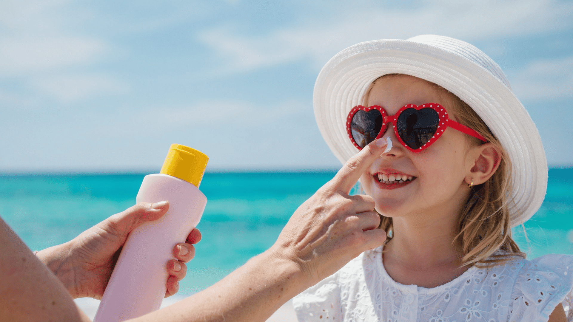 Applying sunscreen outdoors to protect face skin from sun damage and support healthy skin care