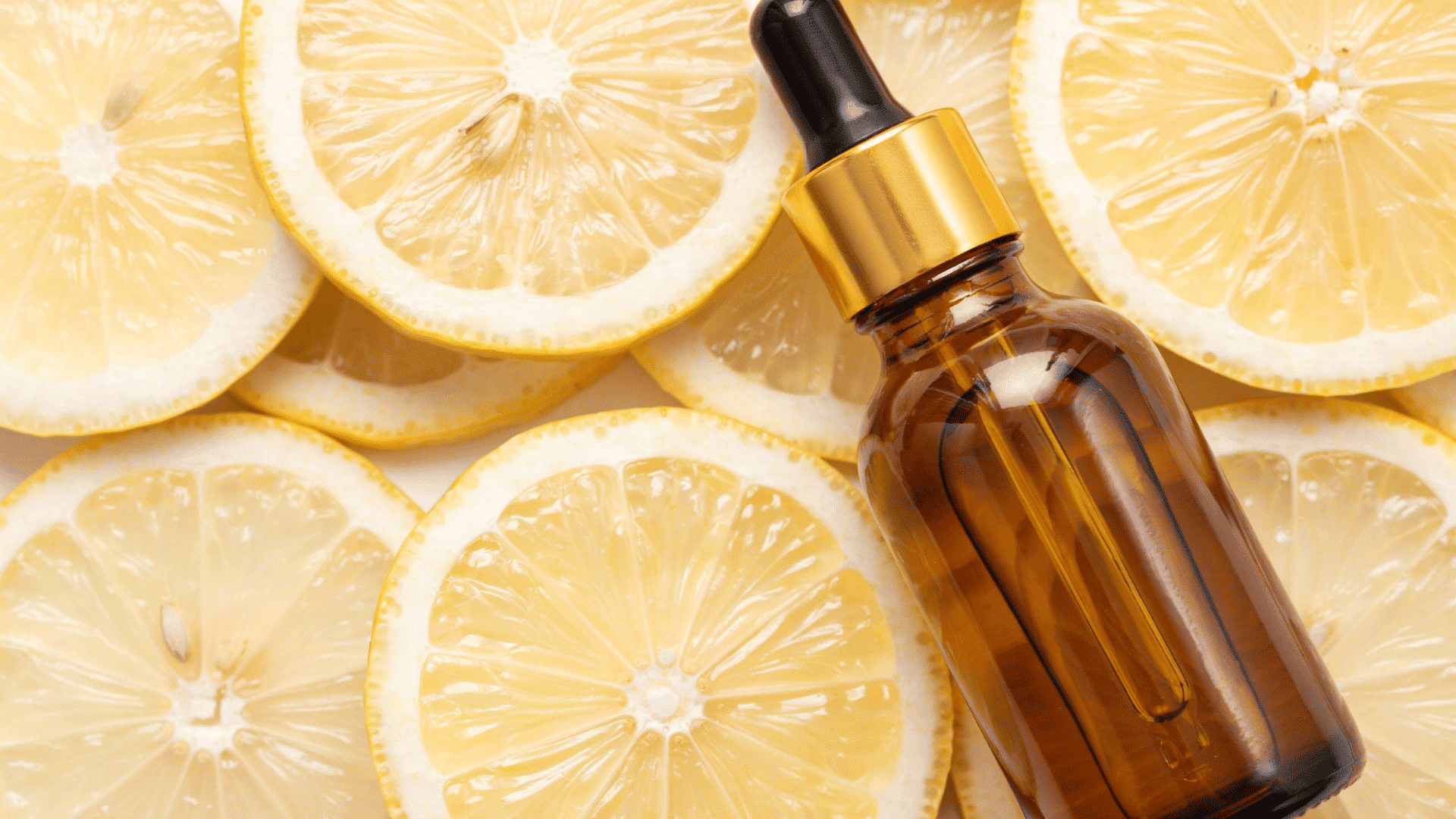 Vitamin C serum bottle with lemon slices for natural face skin care routine at home