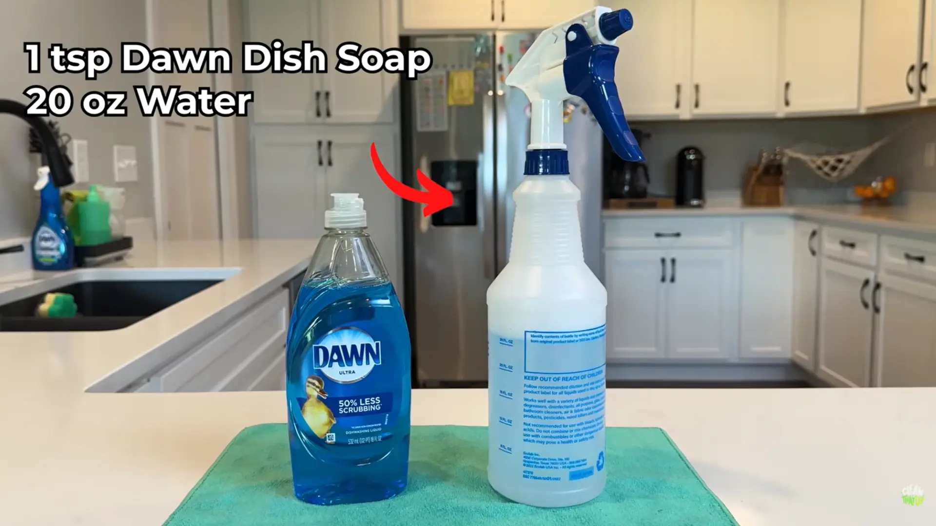 wiping quartz countertop with mild soap solution using soft microfiber cloth in kitchen