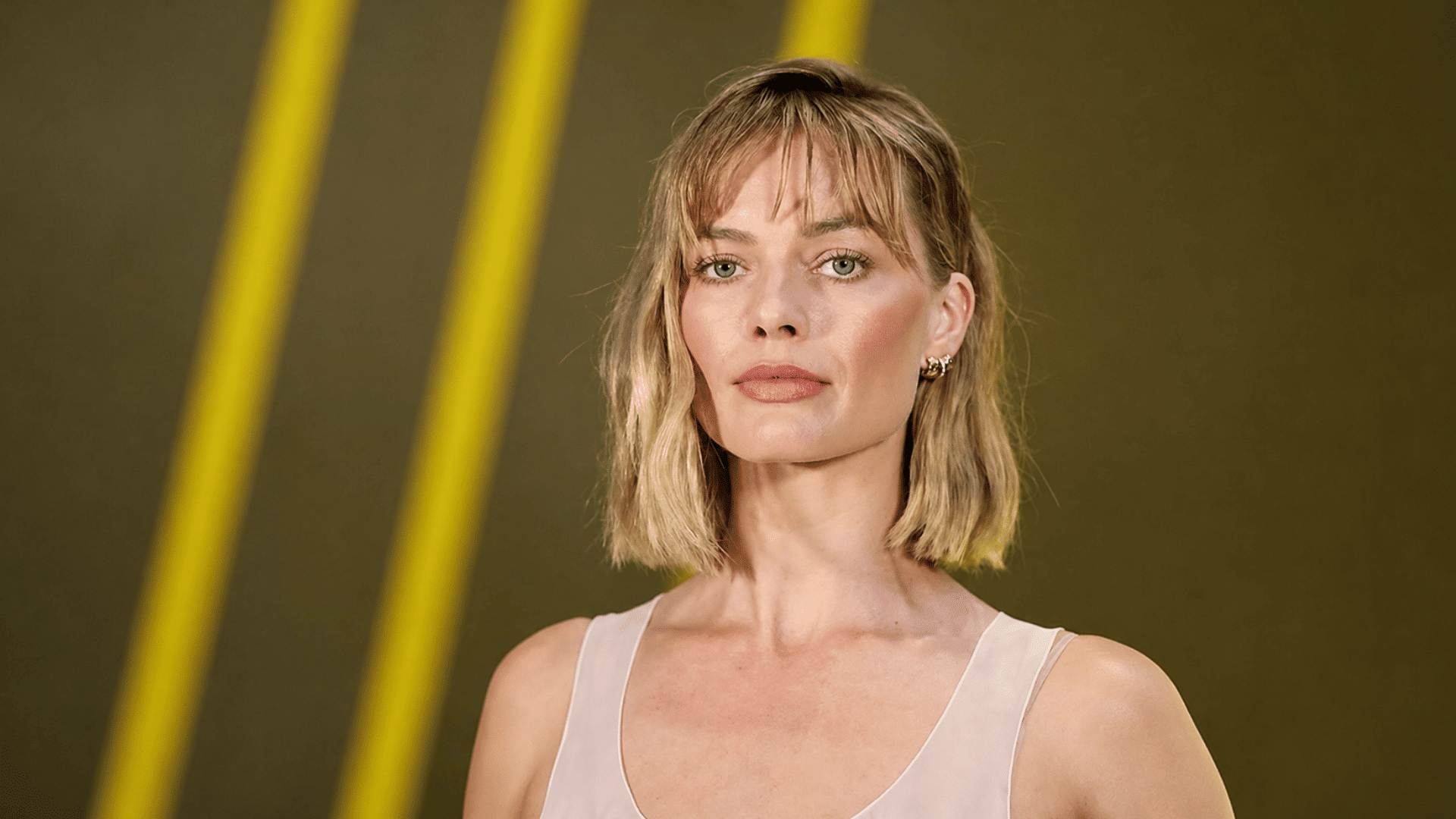 a blonde layered bob with wispy bangs and textured ends creates a soft relaxed hairstyle with natural movement