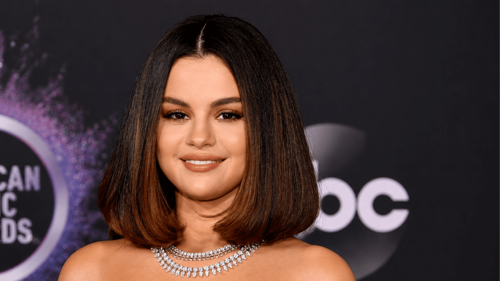 a smooth center parted layered bob with softly curved ends frames the face and creates a polished balanced hairstyle