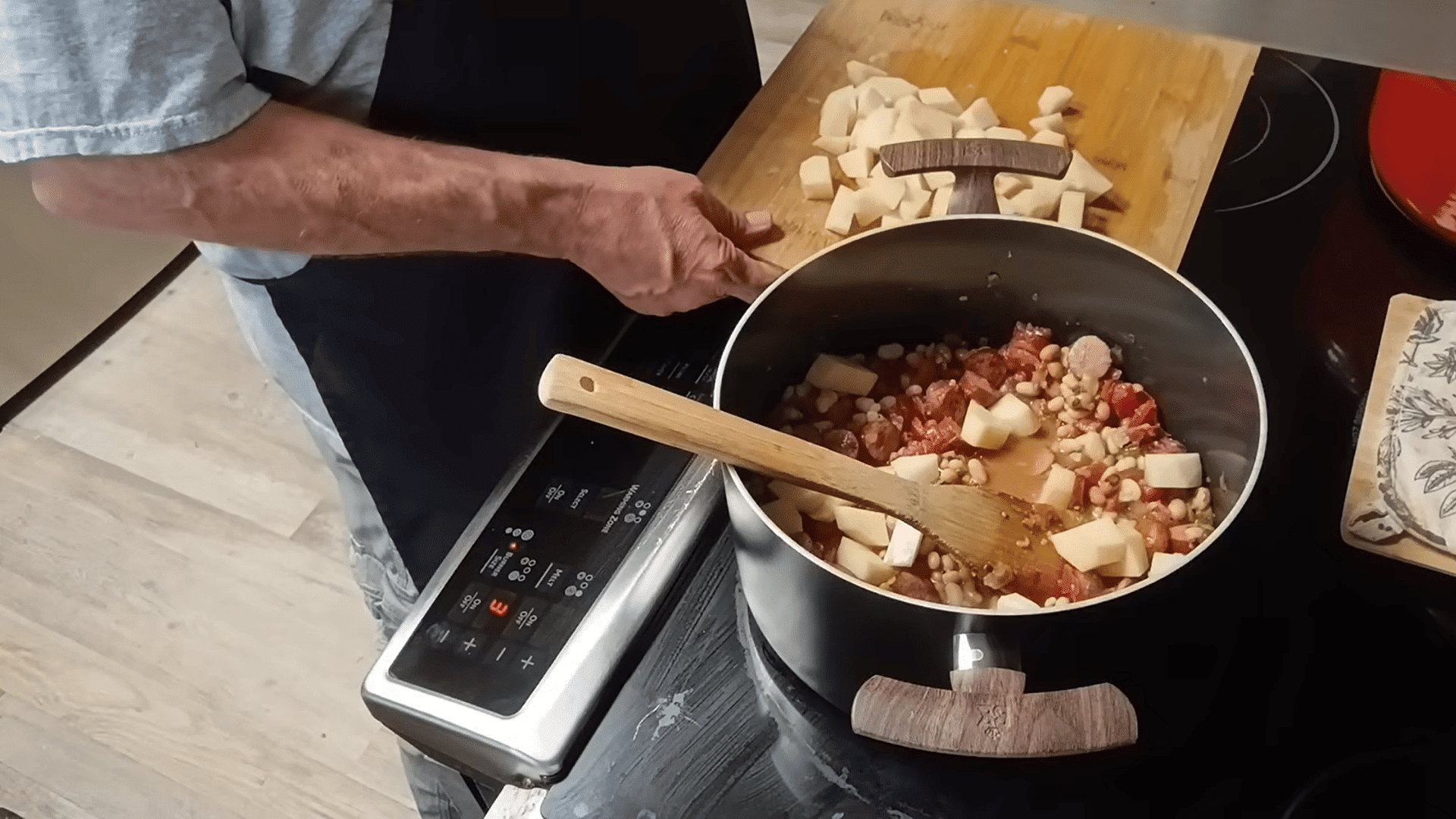 adding beans, tomatoes, and diced potatoes to the pot for swamp soup.