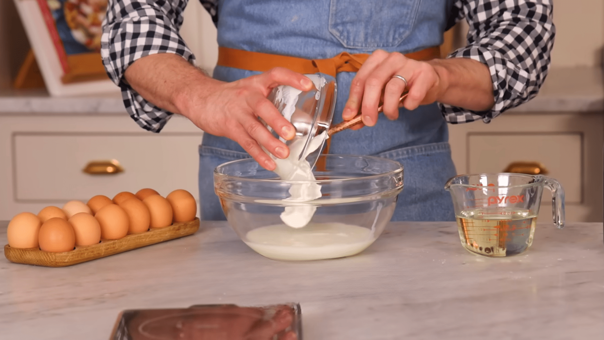 adding vegetable oil eggs and vanilla to the wet ingredients for chocolate sheet cake