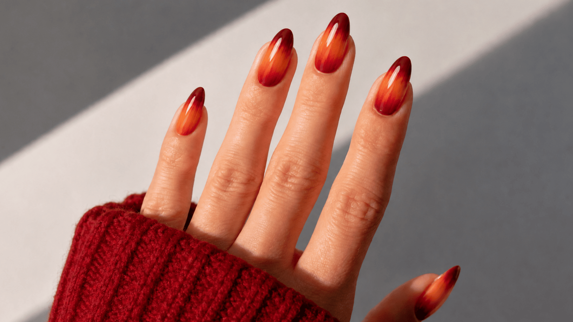 autumn sunset fall ombre nails with nude bases fading into warm orange and deep red tips