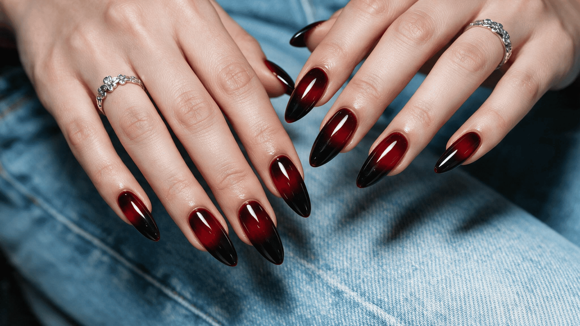 black cherry ombre nails on long almond shaped nails fading from deep burgundy red to black tips