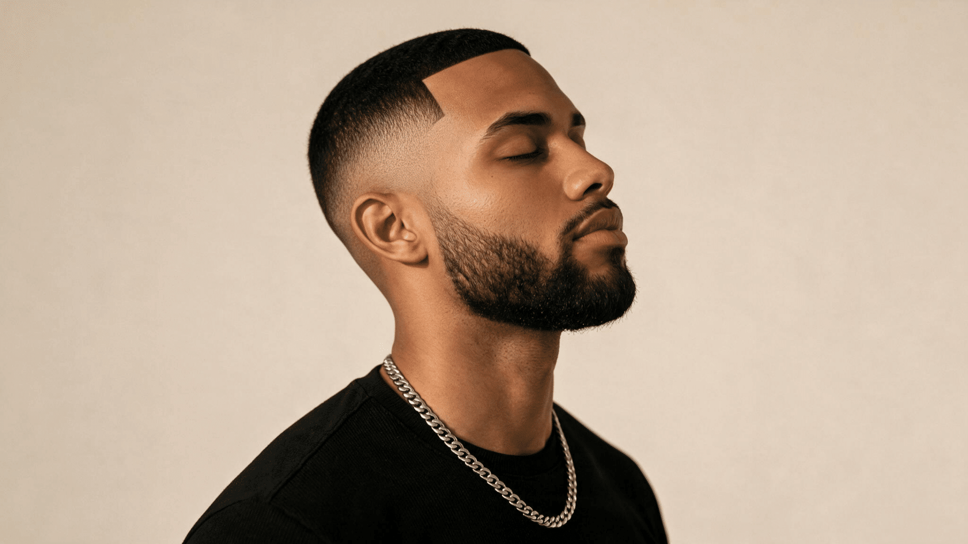 black man with a classic mid fade haircut featuring a short textured top and sharp line up