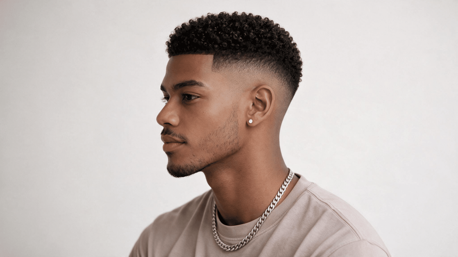 black man with a short natural afro and clean mid fade creating a balanced textured hairstyle