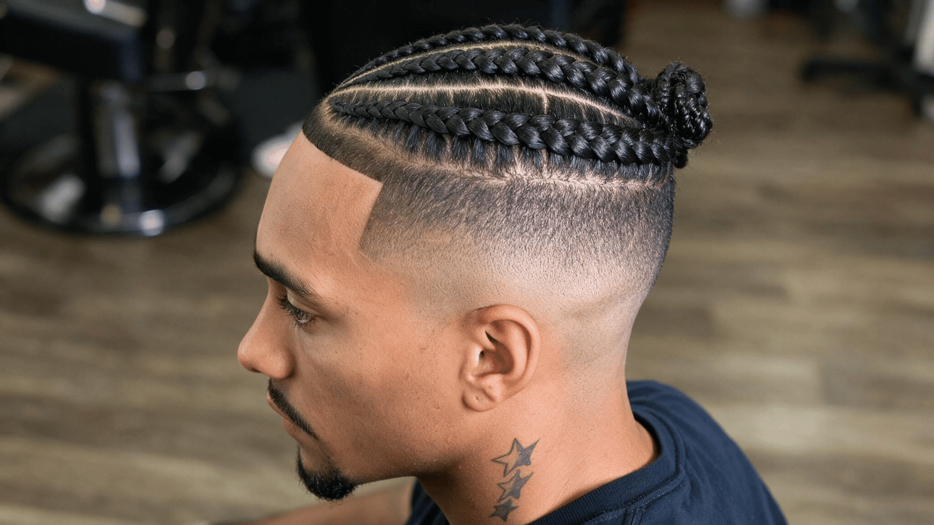 black man with defined braids and a smooth mid fade with a sharp line up around the temples