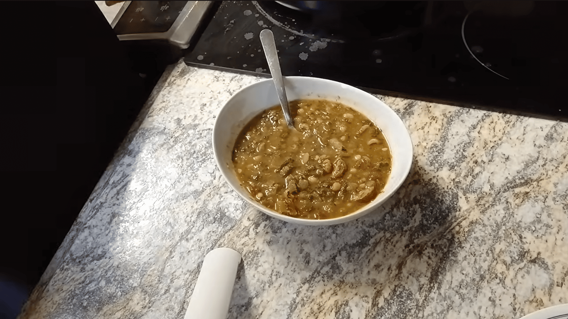 bowl of finished swamp soup with smoked sausage, beans, greens, and potatoes ready to serve.