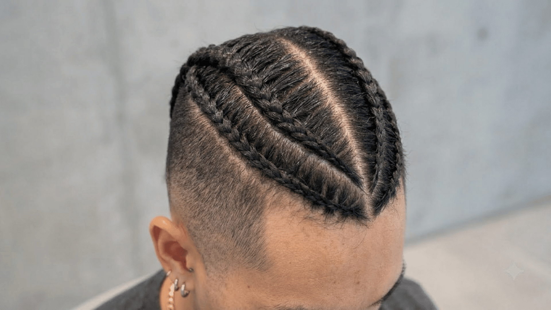 braided mohawk with neat cornrow braids through the center and closely shaved sides