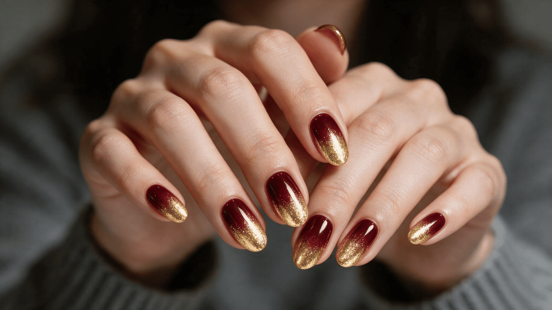 burgundy and gold glitter ombre nails with deep wine red bases fading into sparkling gold tips