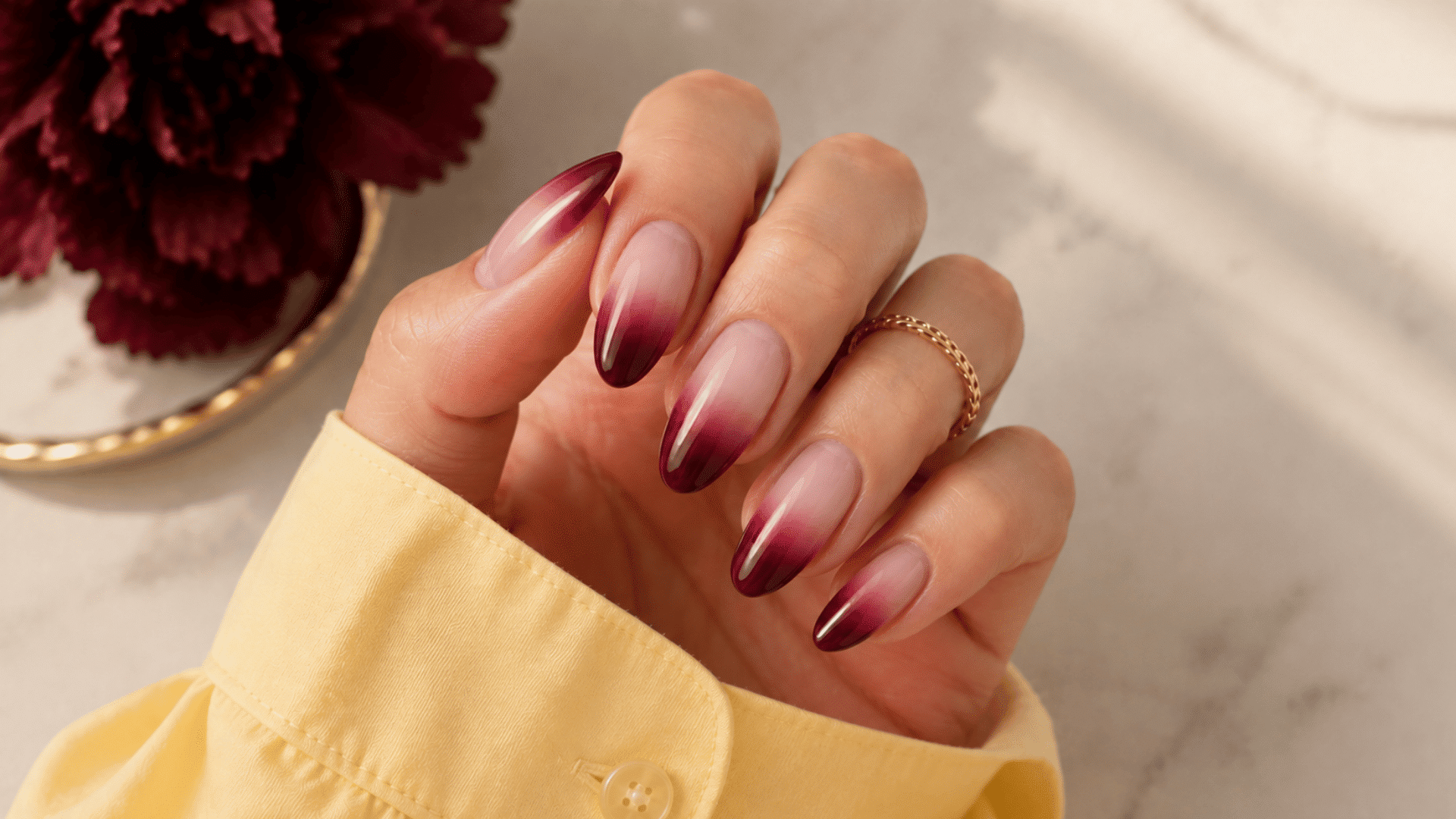 burgundy french ombre nails with nude bases deep red tips and fine gold glitter accents