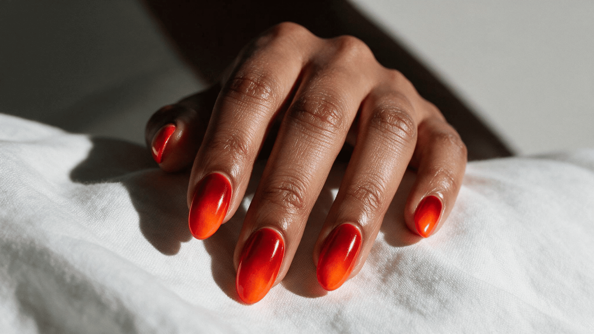 burnt orange matte ombre nails on almond shaped nails with a warm red to orange gradient