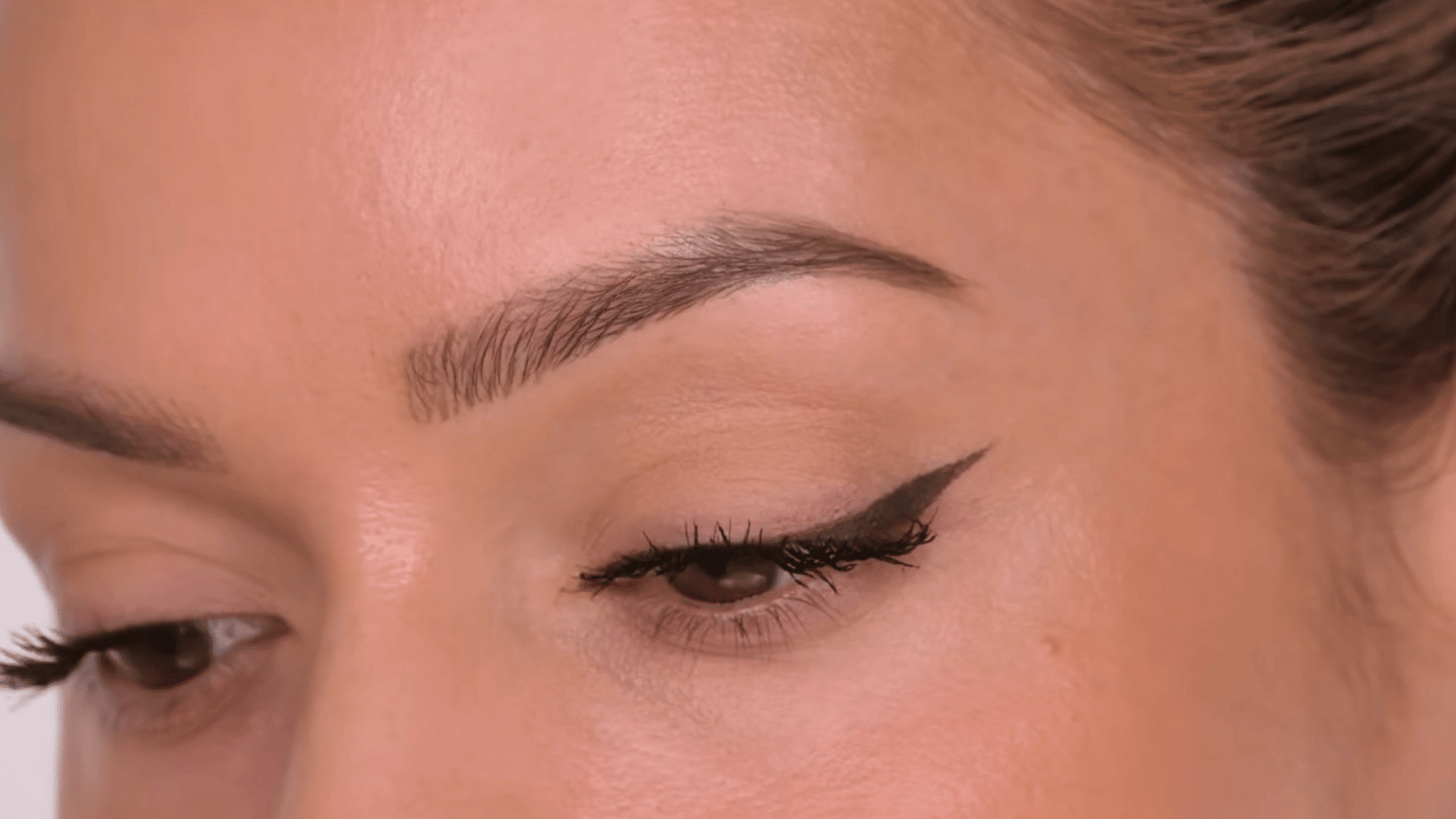 checking the finished cat eye for even wings smooth lines and balanced definition across both eyes