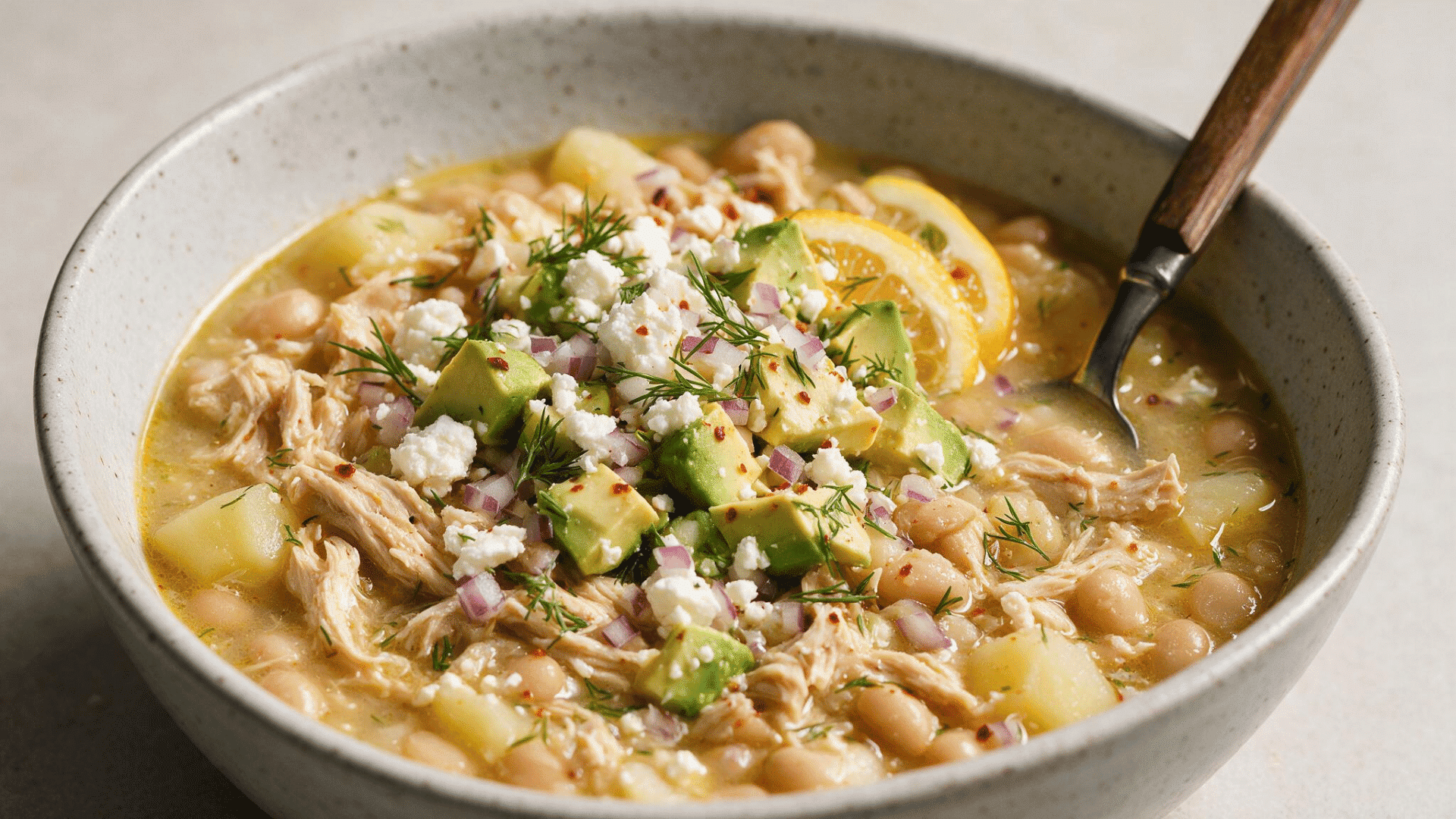 Chicken and white bean soup with corn green vegetables and herb sauce