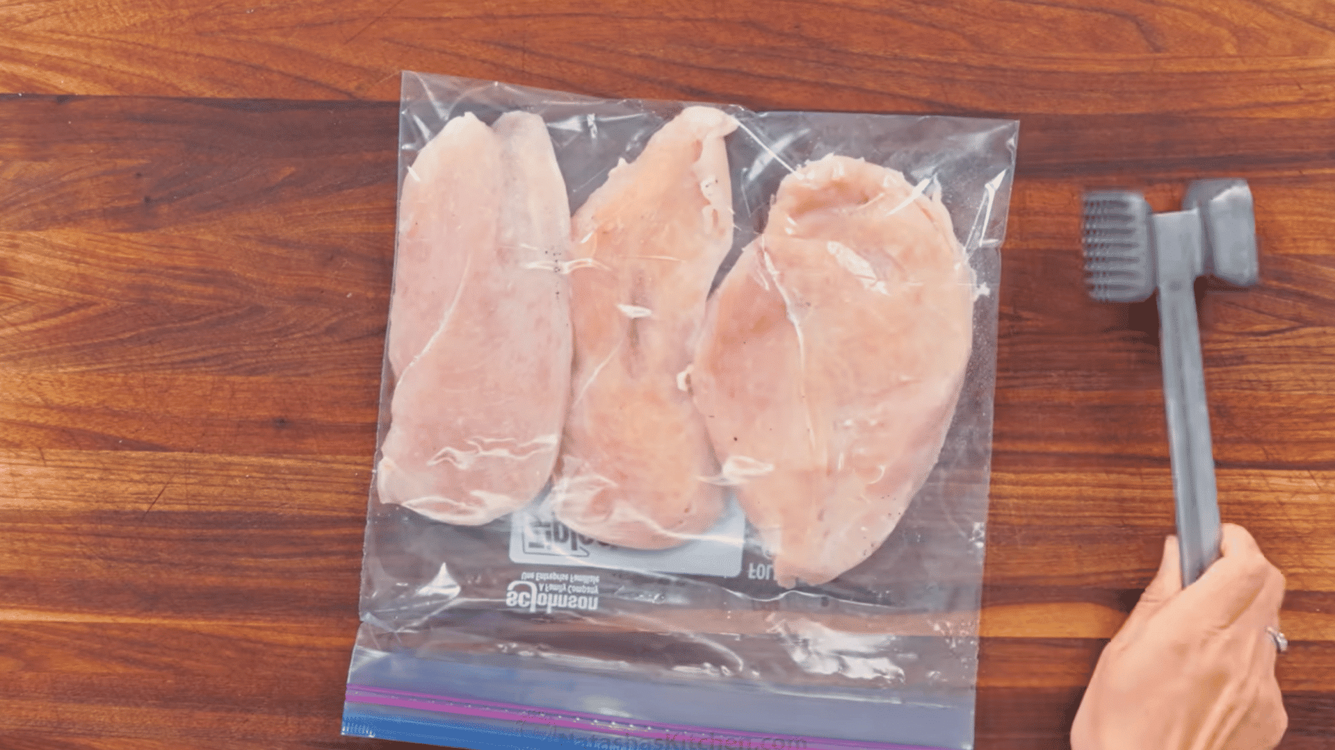 chicken cutlets in a zip-top bag ready to be pounded evenly with a meat mallet.