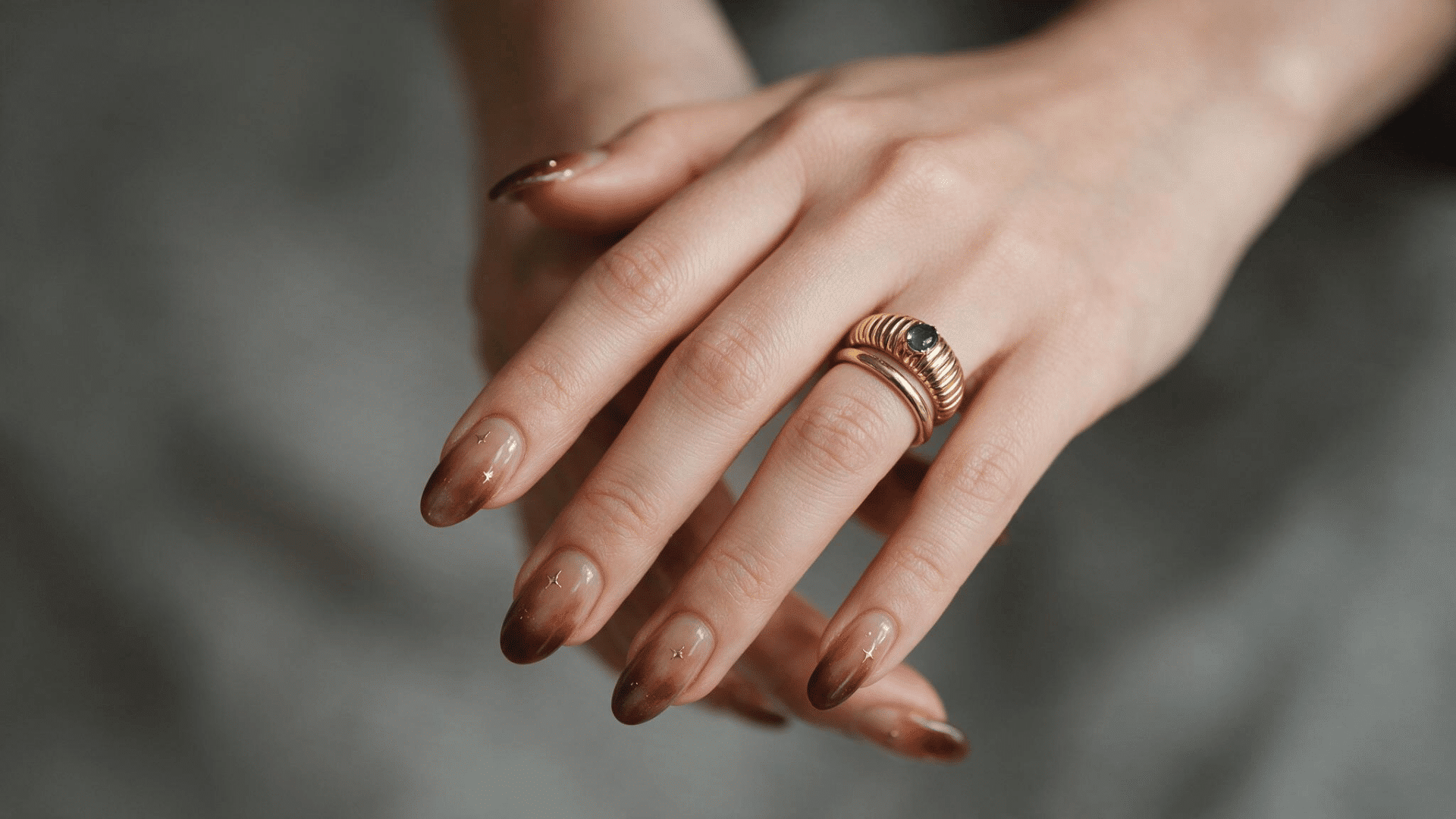 chocolate brown ombre nails with nude bases fading into rich cocoa brown tips on almond shaped nails