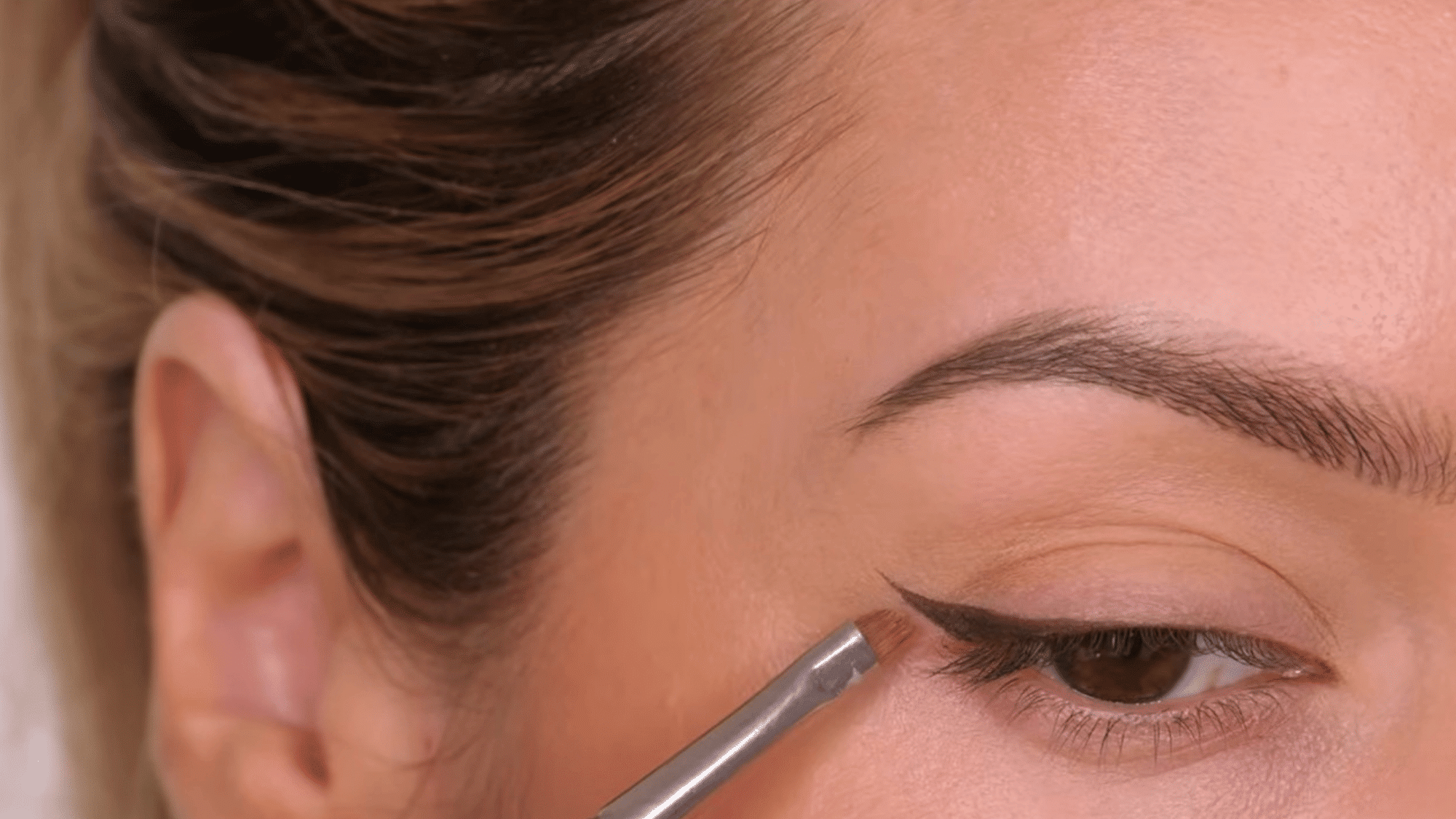 clean and sharpen the eyeliner edges for a crisp winged look with precise smooth lines and defined corners