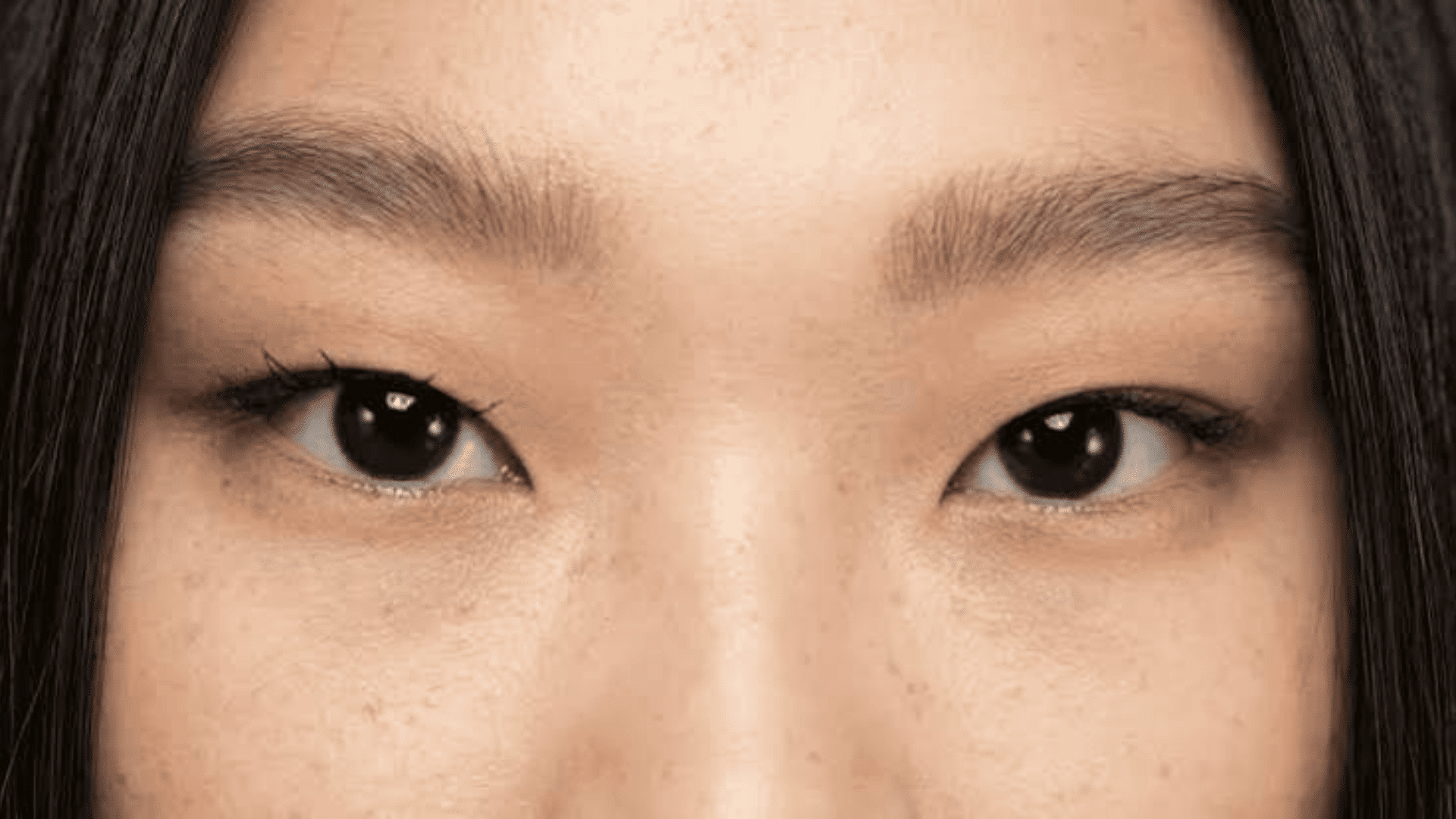 close view of monolids showing smooth upper eyelids without a visible eyelid crease