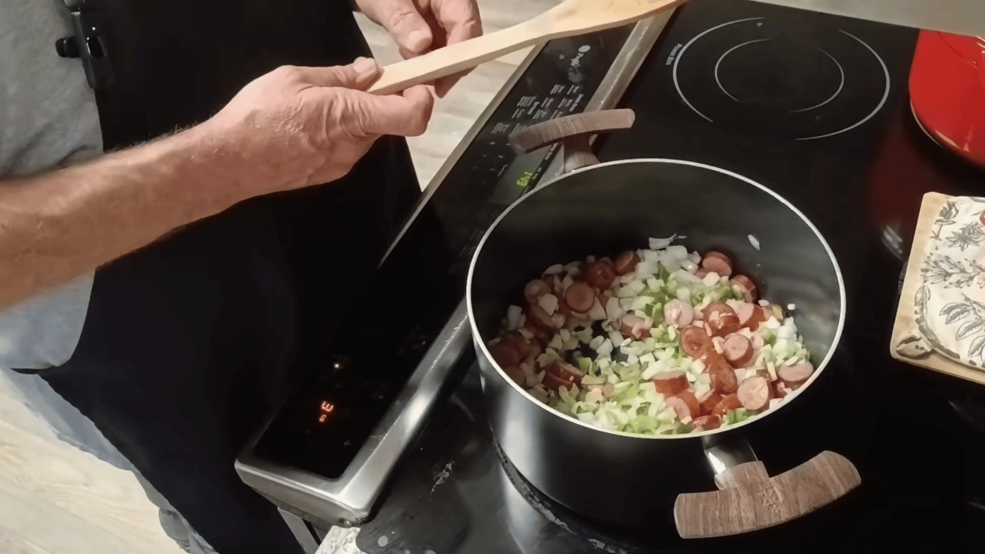cooking onions, celery, and bell peppers with smoked sausage for swamp soup.