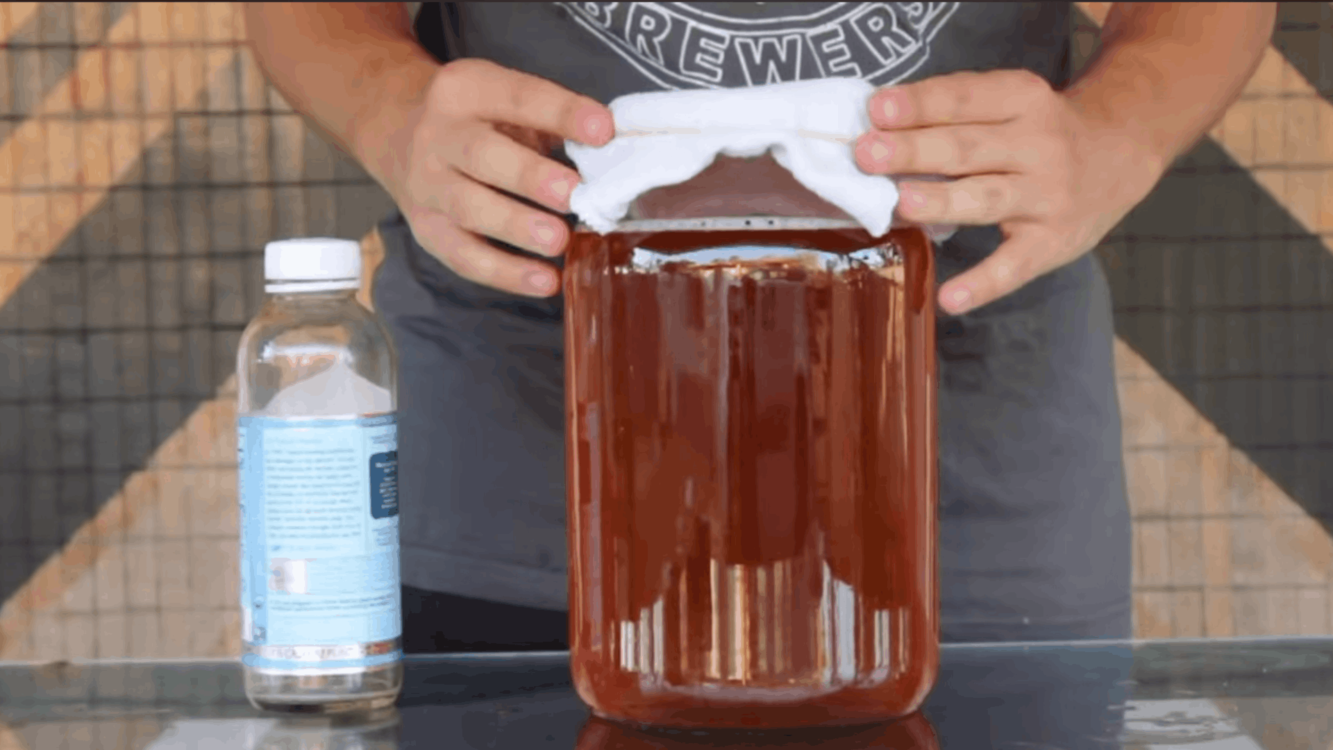 covering a glass kombucha jar with breathable cloth before placing it in a warm spot to ferment