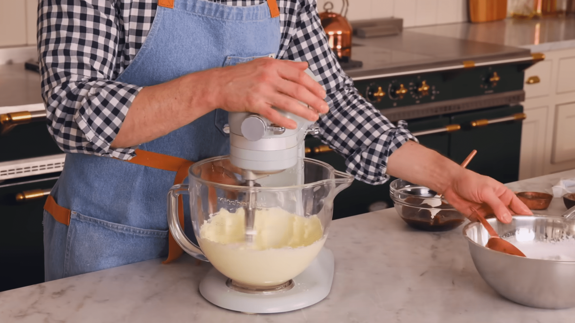 creaming softened butter in a stand mixer to prepare smooth chocolate buttercream frosting