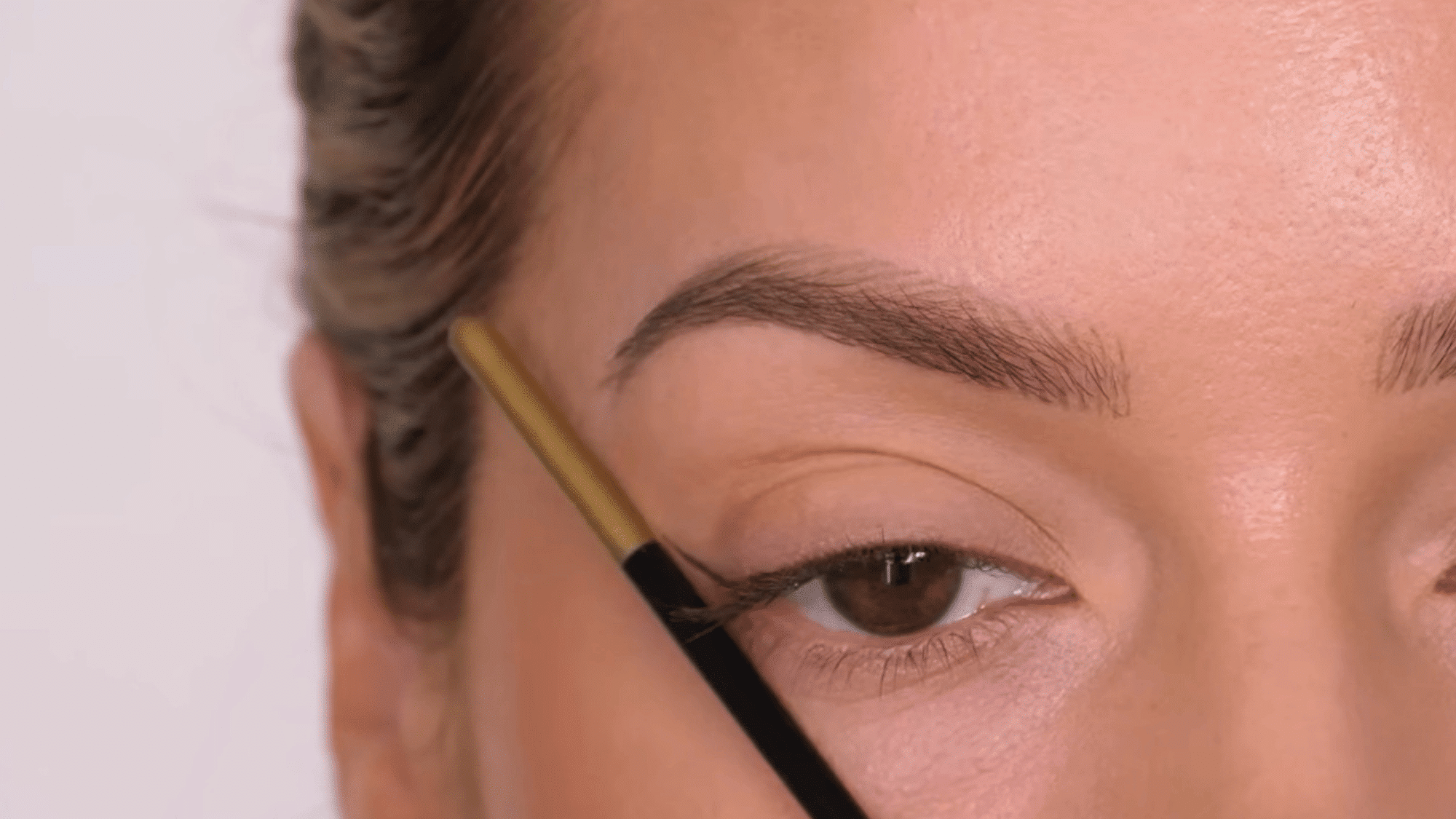 create the wing trajectory with eyeliner extending upward from the outer corner for a defined eye look