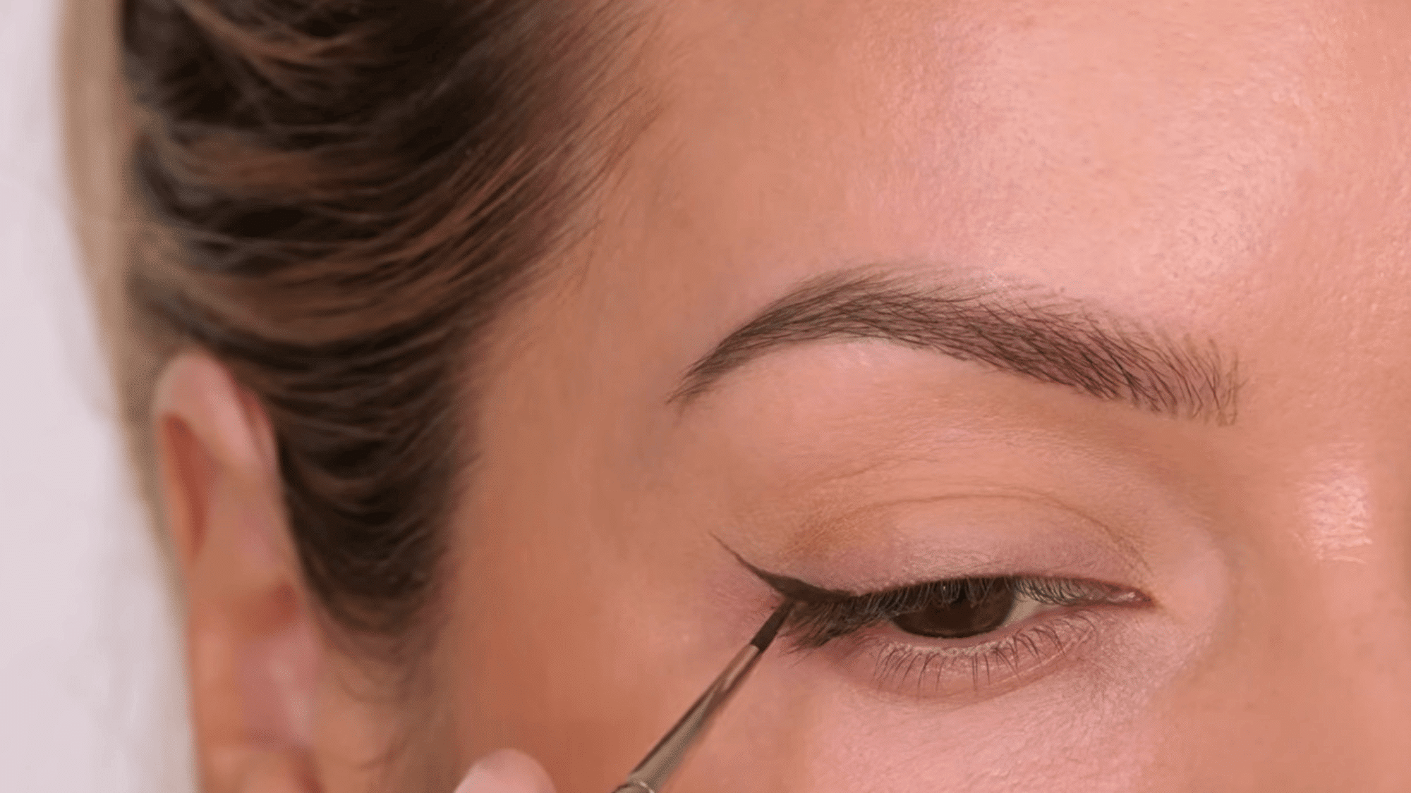 draw a small triangle at the outer corner to shape the wing and create a clean defined eyeliner look