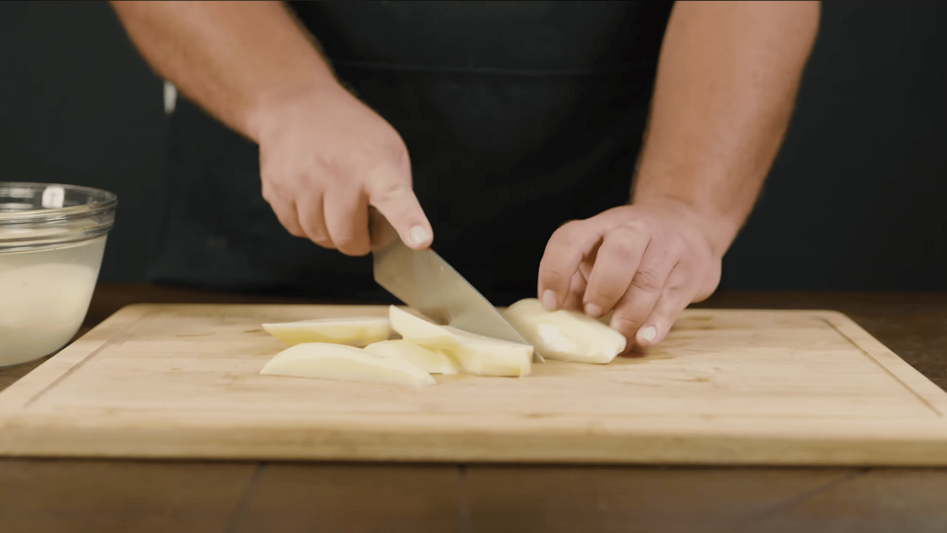 evenly cut potato pieces arranged on a cutting board ready for boiling in a large pot
