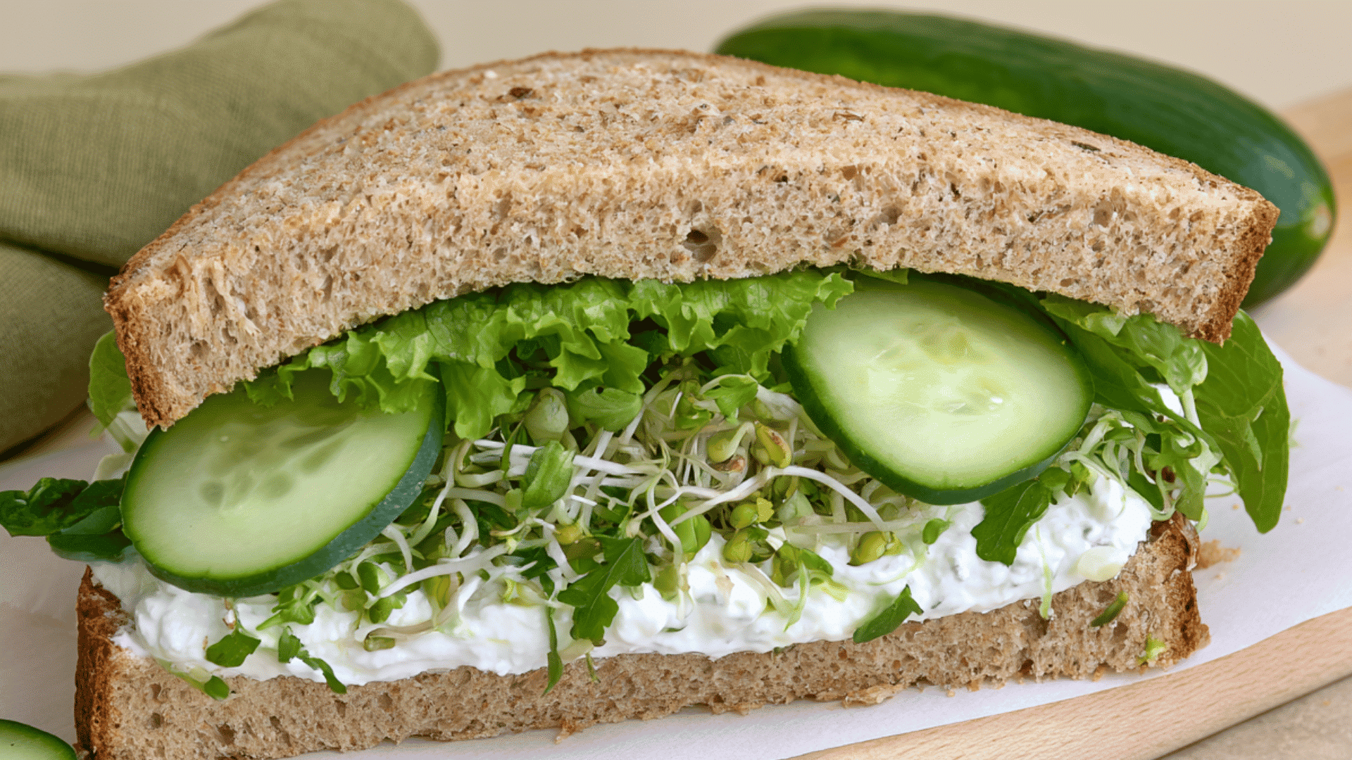 high protein cucumber sandwich with cottage cheese lettuce sprouts and greens on whole grain bread