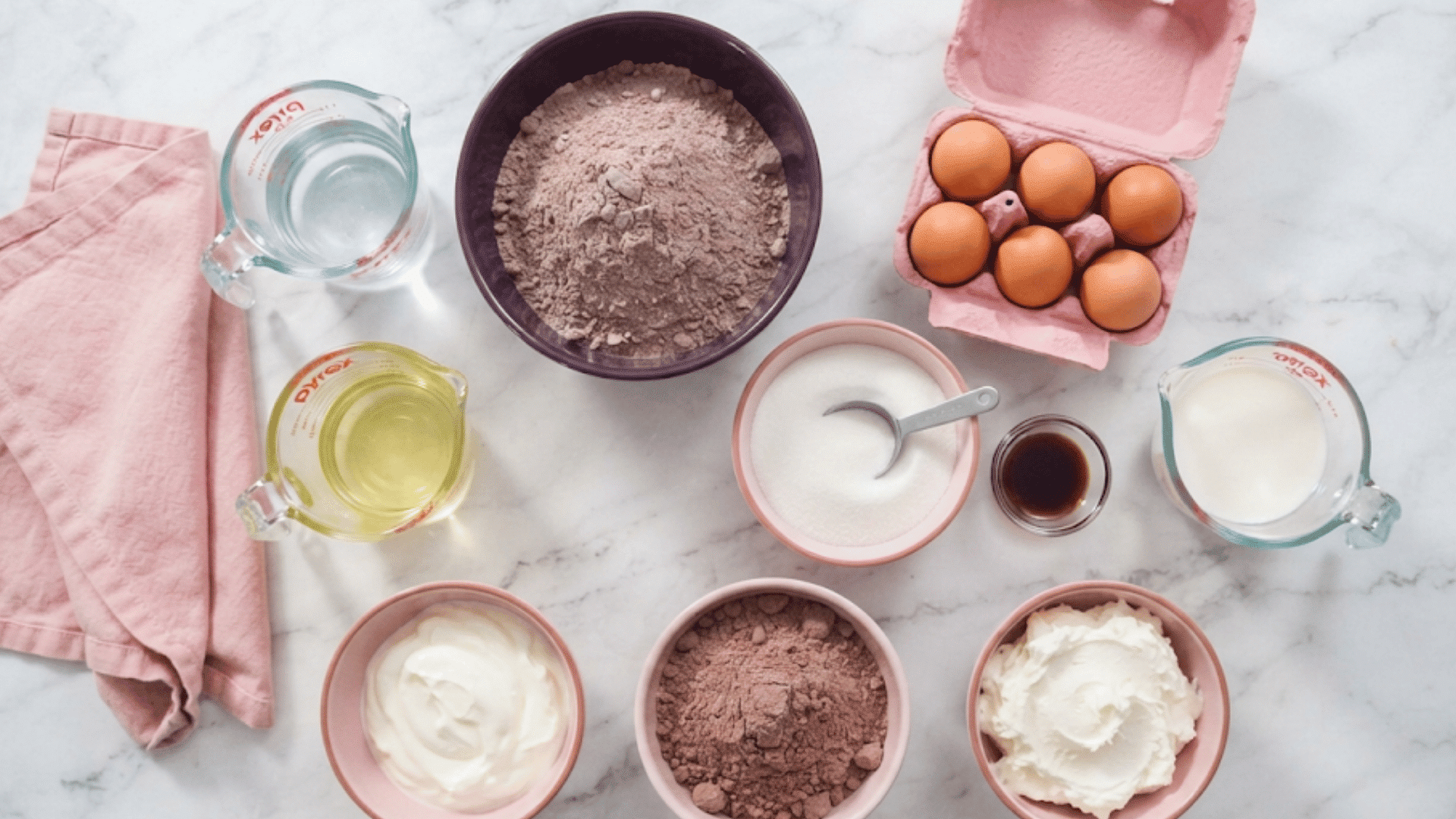 italian love cake ingredients with cake mix eggs sugar milk oil vanilla cocoa and creamy fillings on marble counter