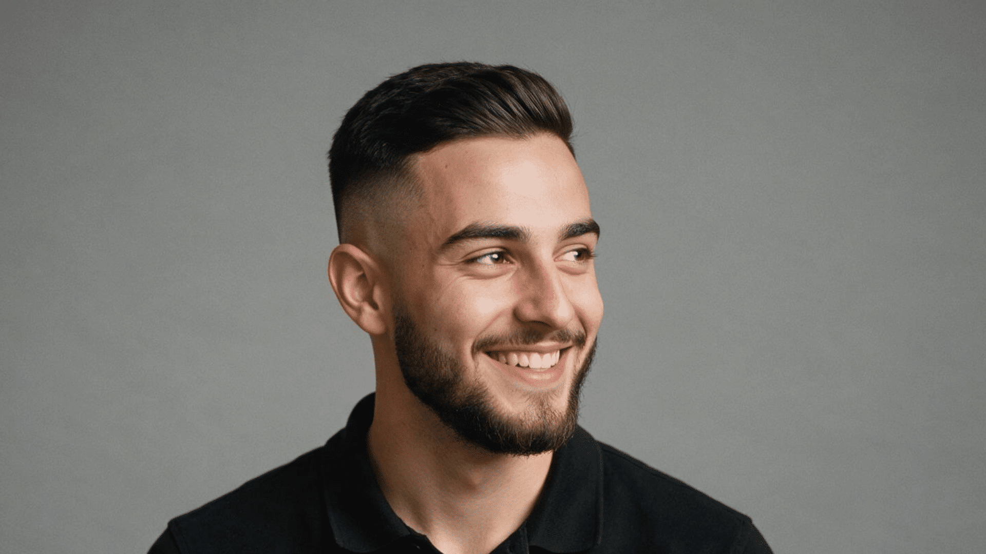 ivy league haircut with neatly styled side swept top and short tapered sides creating a polished professional hairstyle