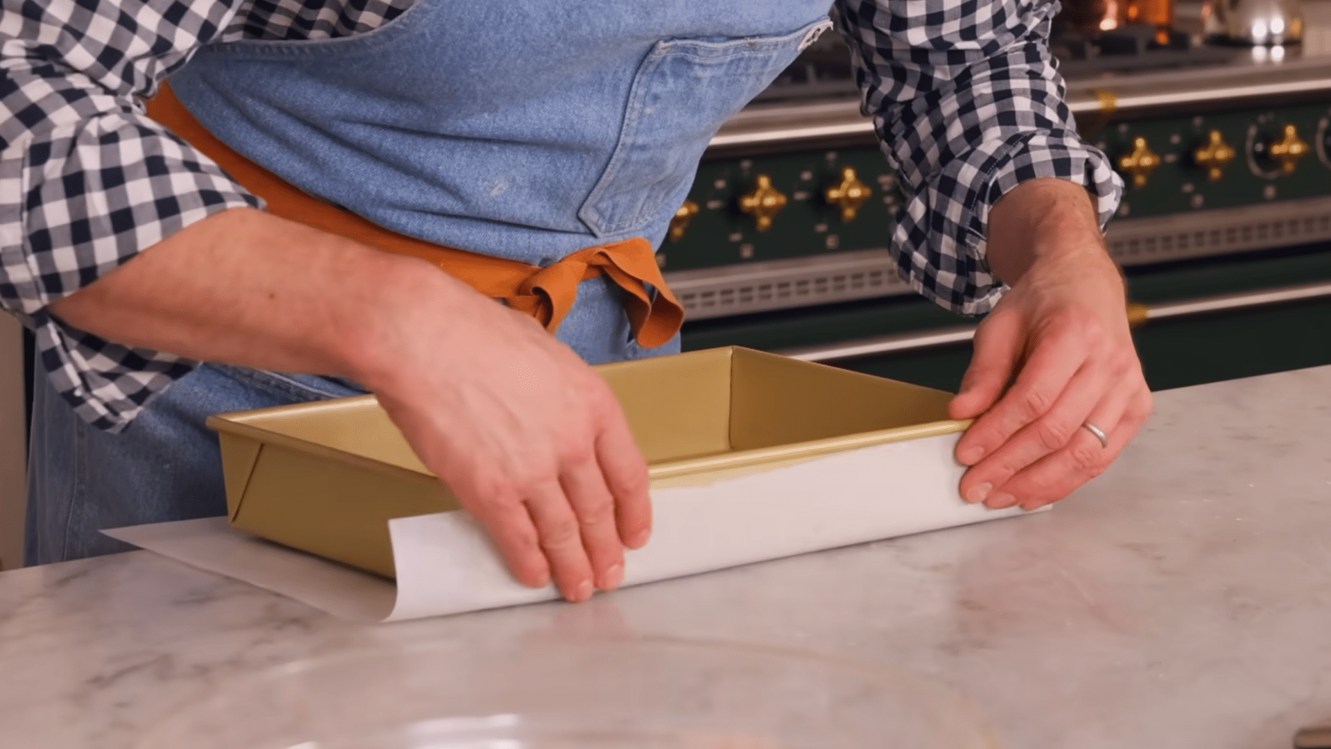 lining a 9 by 13 inch baking pan with parchment paper for easy cake removal