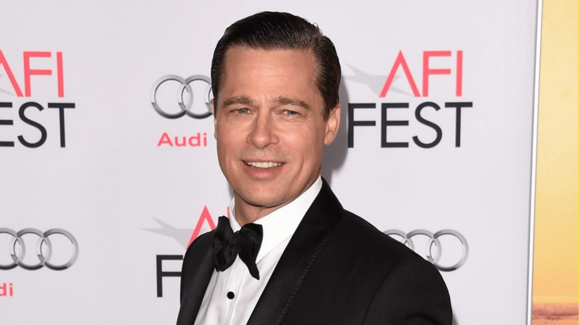 man wearing a classic gentleman haircut with black tuxedo white shirt and bow tie at a formal event