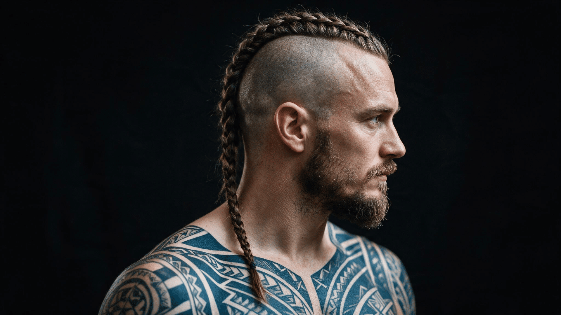 man wearing a viking mohawk with long braided center hair and closely shaved hair along both sides of the head