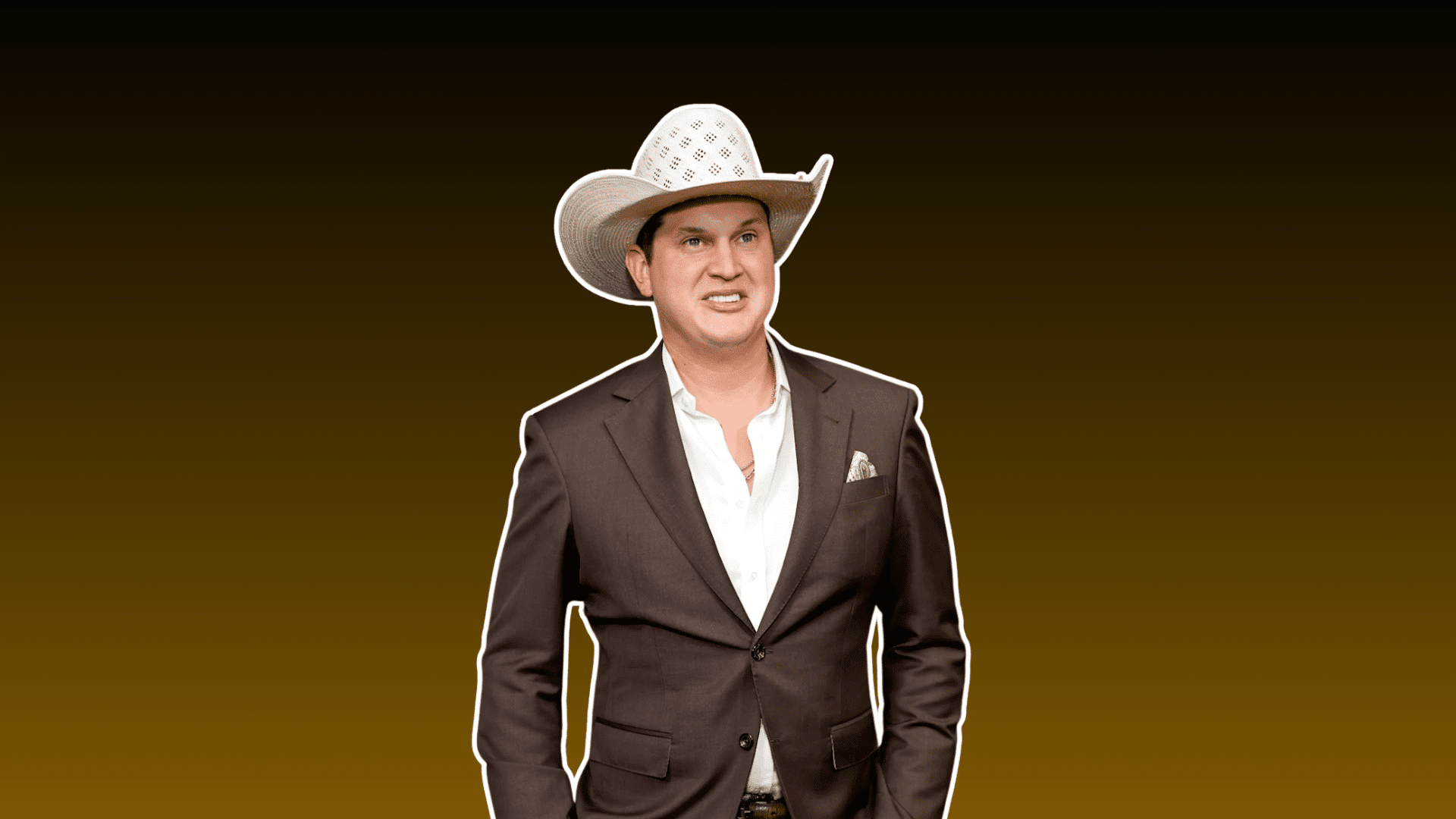 man wearing a white cowboy hat and brown suit posing against a dark brown background in a country style portrait