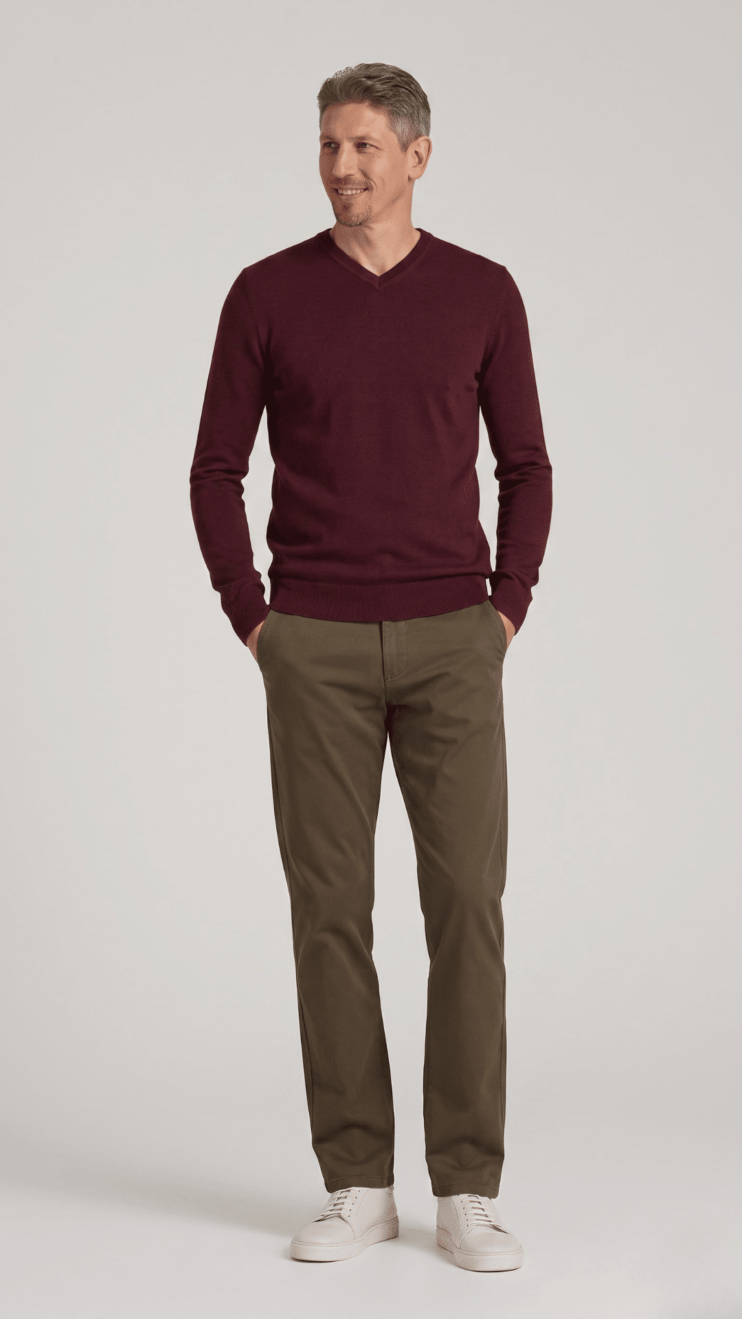 man wearing dark khaki pants with a burgundy sweater and brown boots for a warm fall outfit