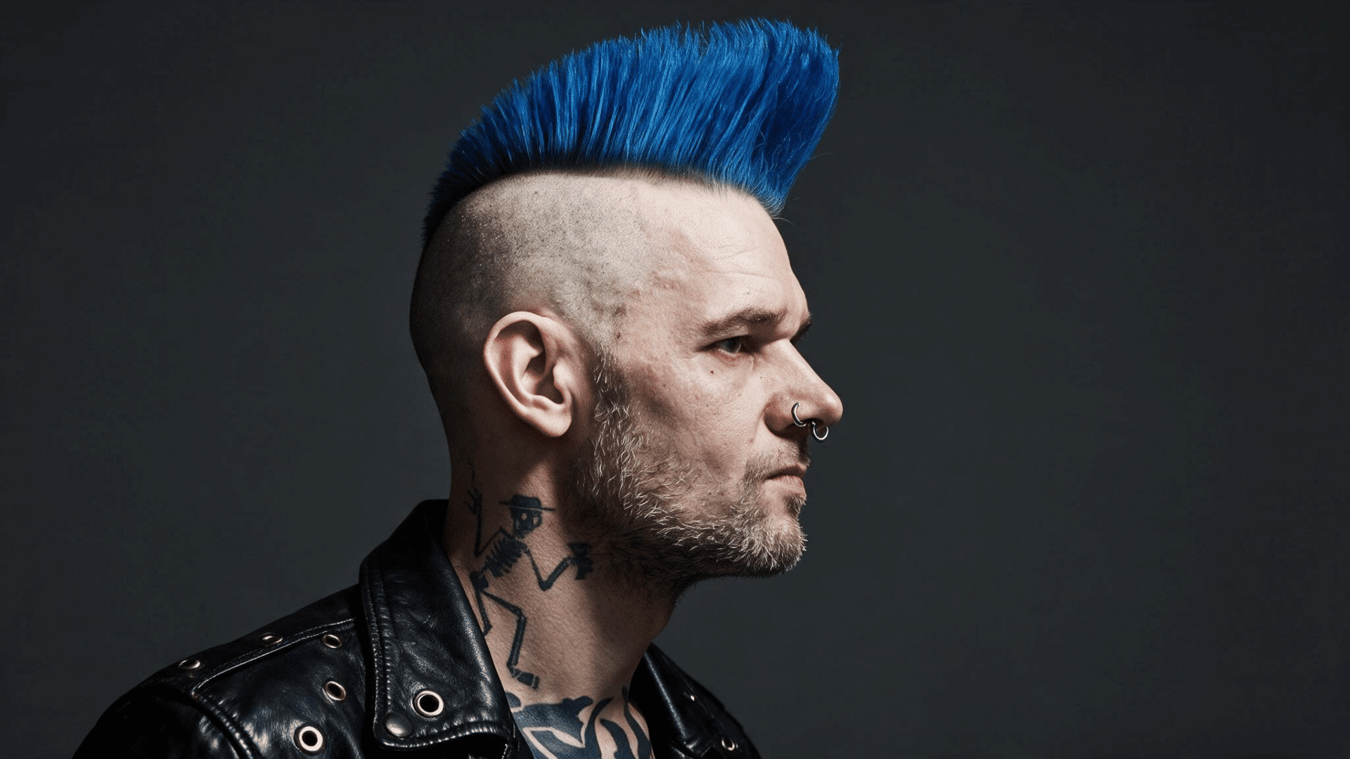 man with a psychobilly mohawk featuring a tall swept center section and closely shaved hair along both sides