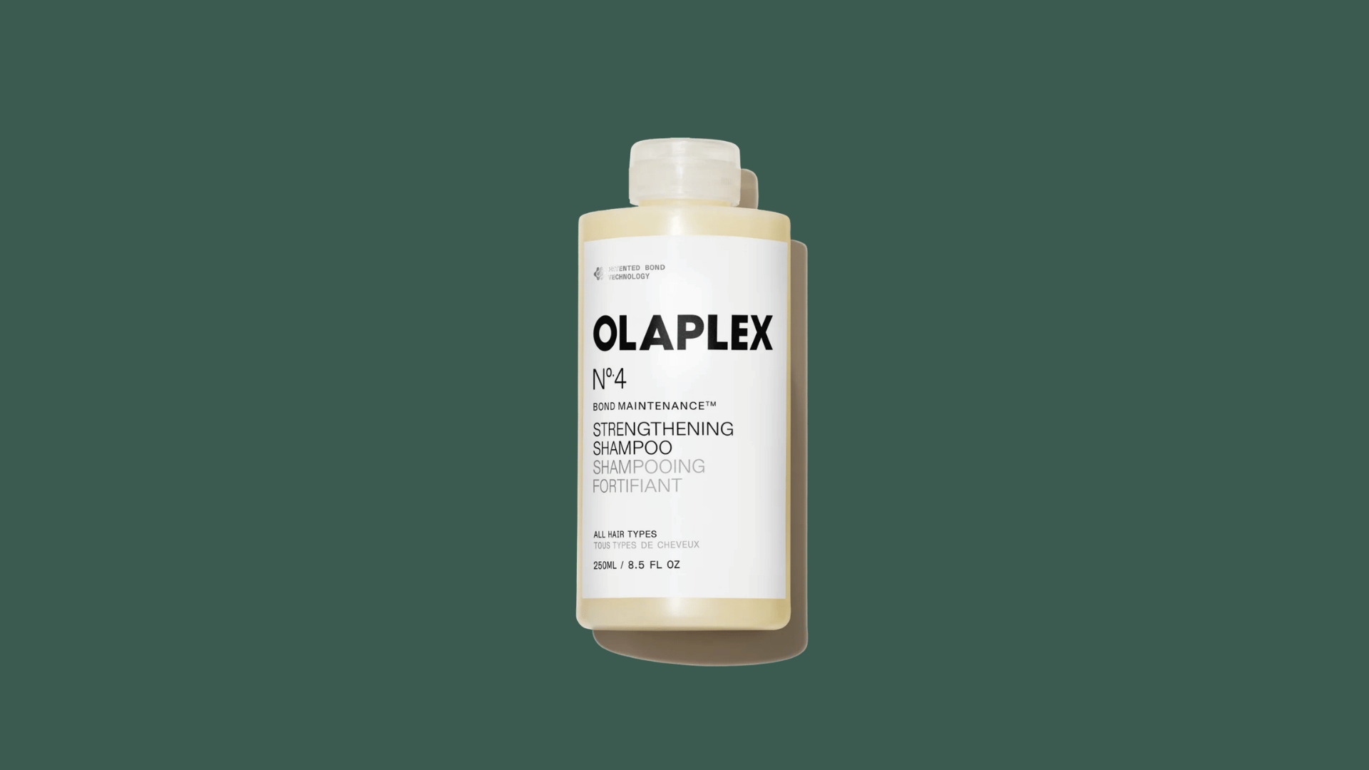 olaplex no 4 strengthening shampoo bottle on a dark green background for hair care product display and beauty use