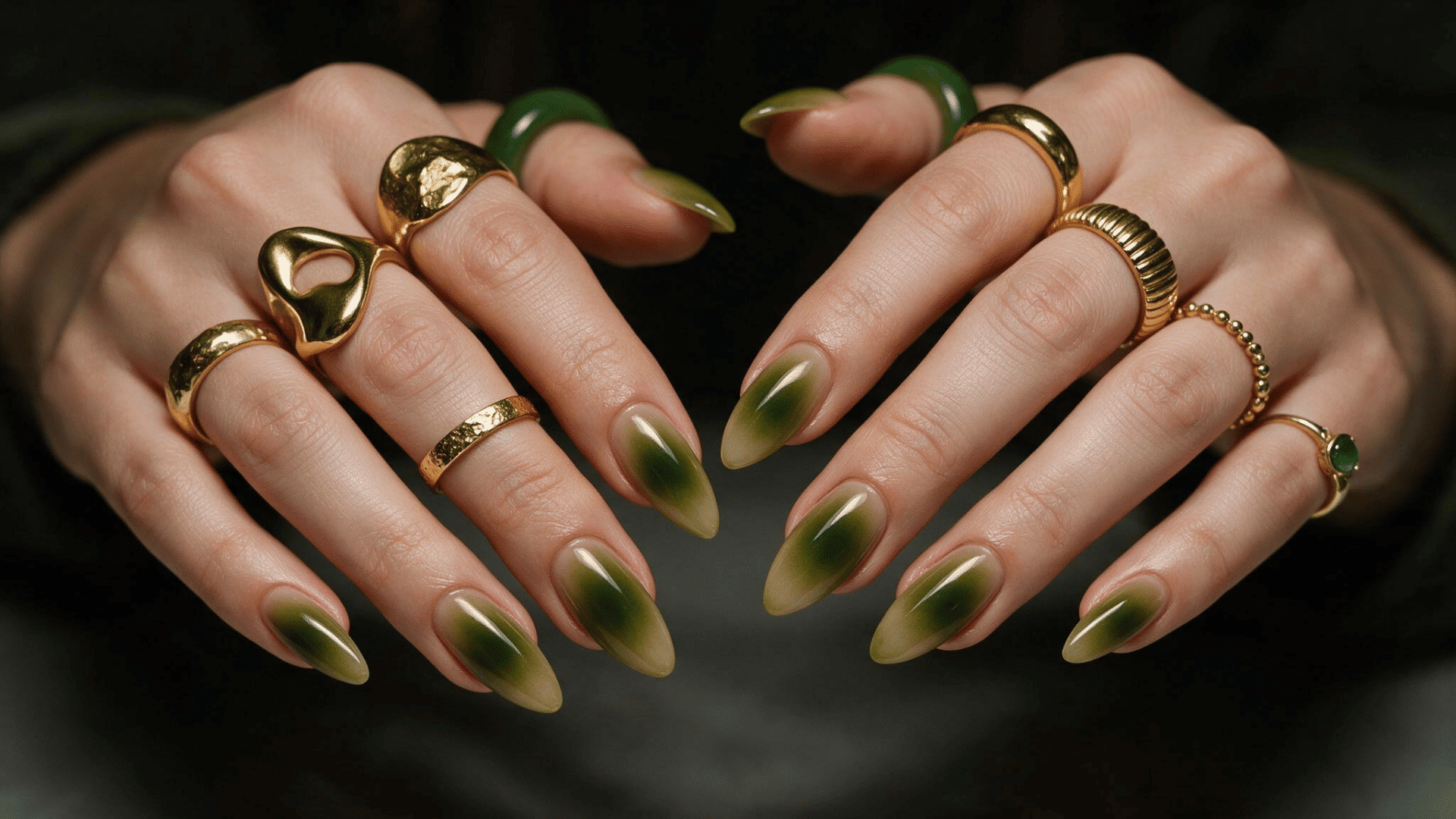 olive green aura ombre nails with deep green centers fading into soft beige edges on almond shaped nails