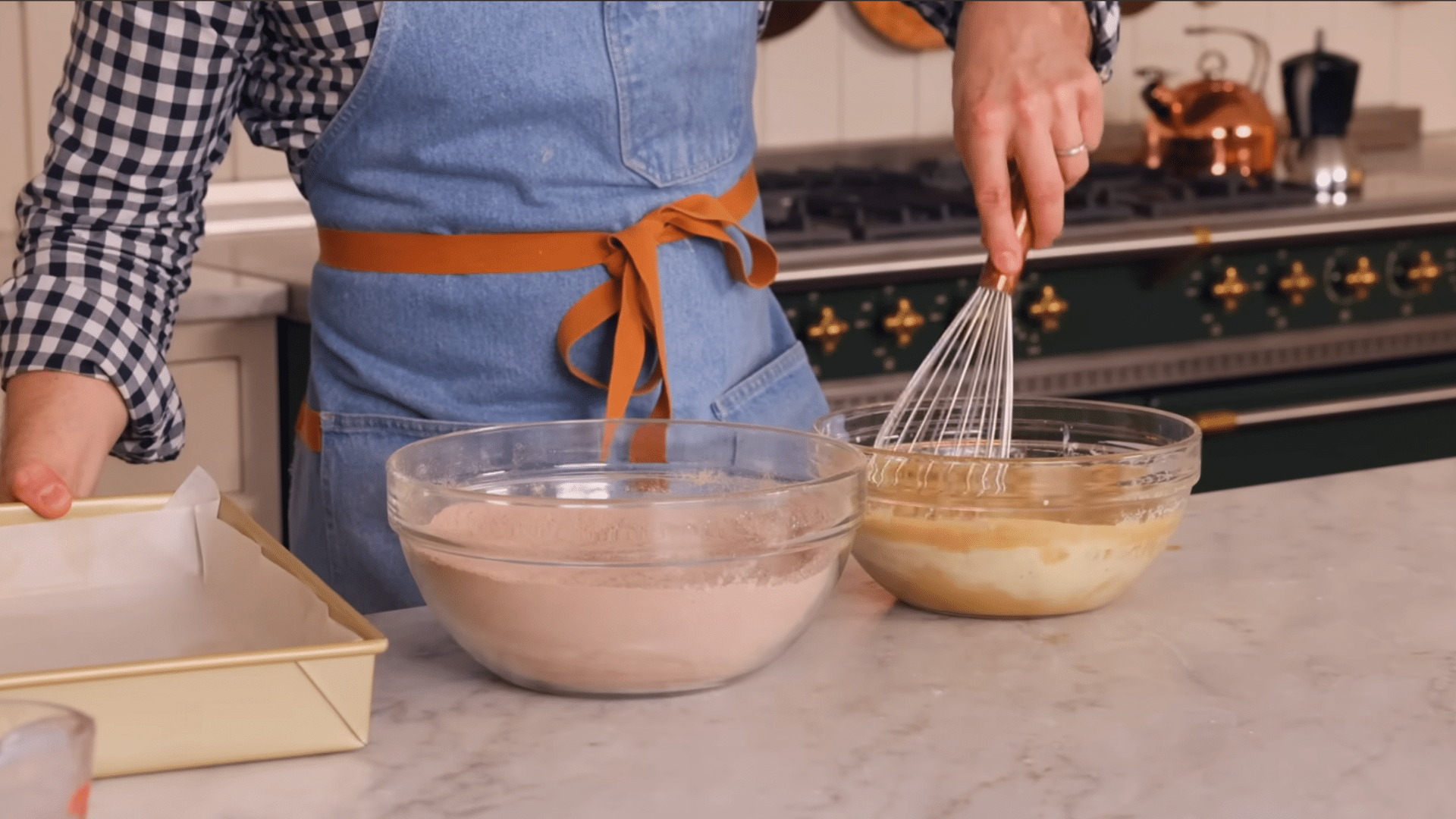 pouring chocolate cake batter evenly into the prepared 9 by 13 inch baking pan