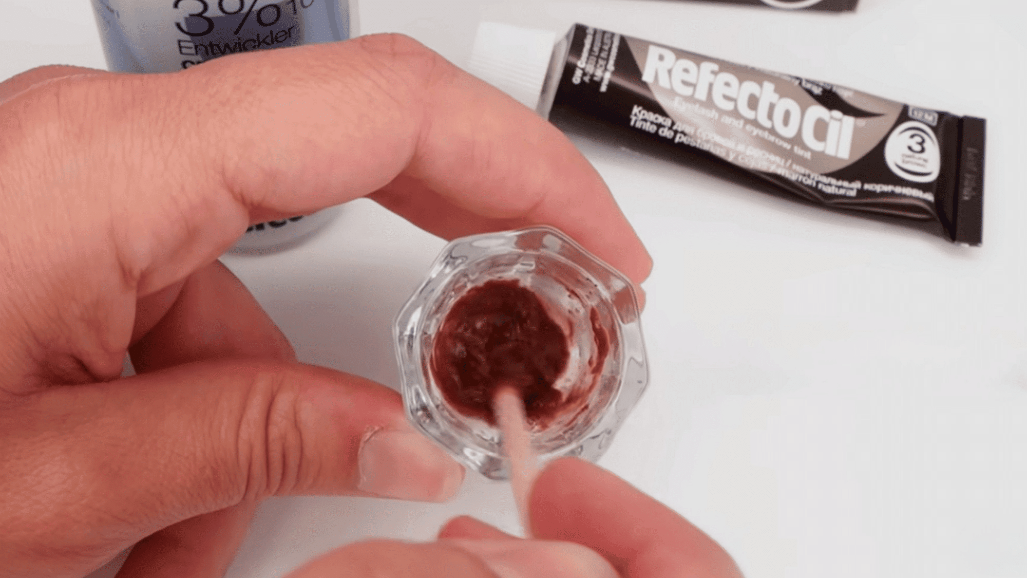 refectocil eyebrow tint mixture being stirred in a glass dish before a patch test is performed