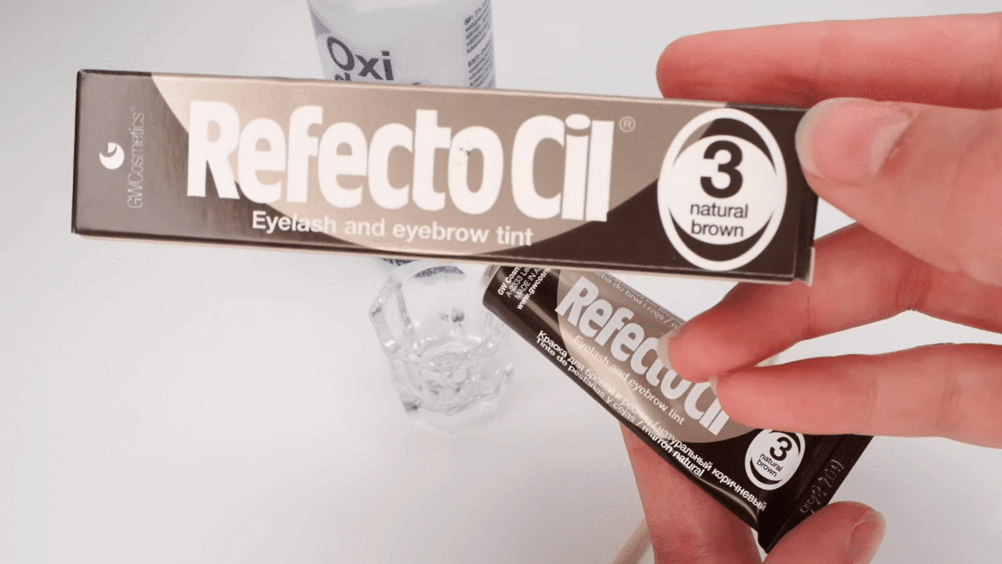 refectocil natural brown eyelash and eyebrow tint box with mixing supplies on a white surface