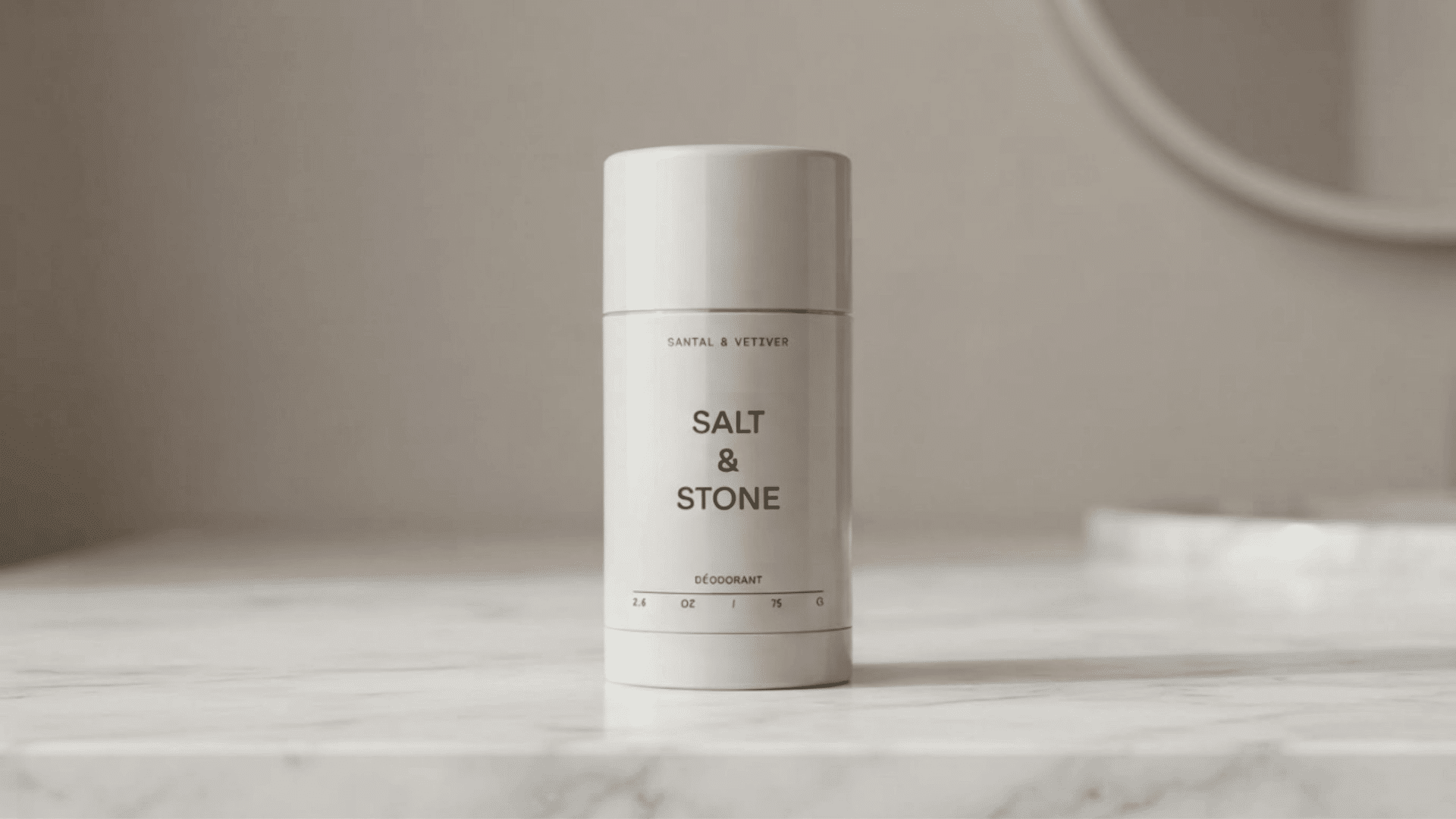 White deodorant stick placed on a marble counter for best natural deodorants