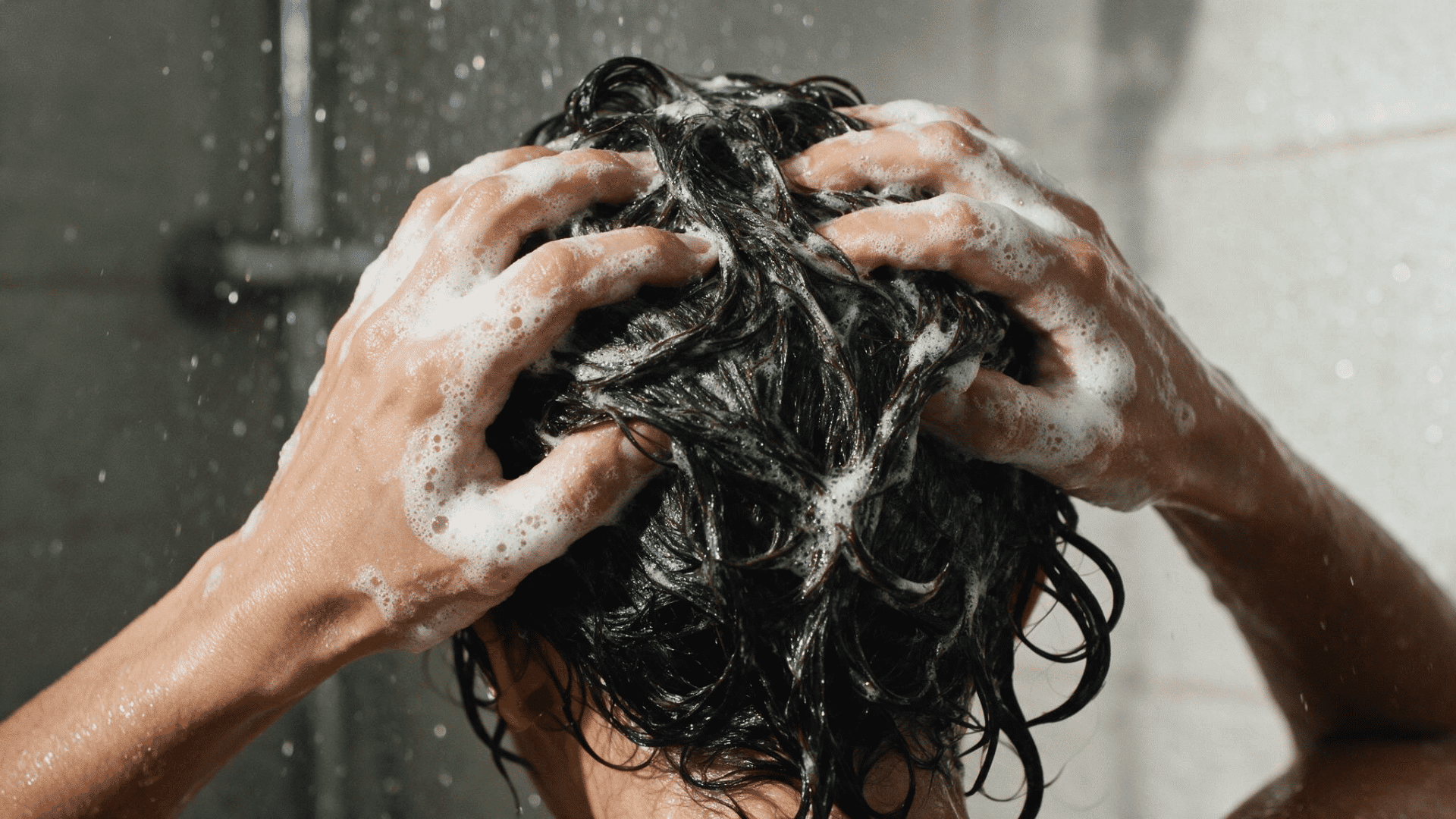 shampoo being massaged into the scalp during a curly hair wash day routine